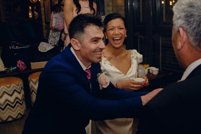 Bride and groom smiling at a wedding tea ceremony at Samuel Pepys in London.