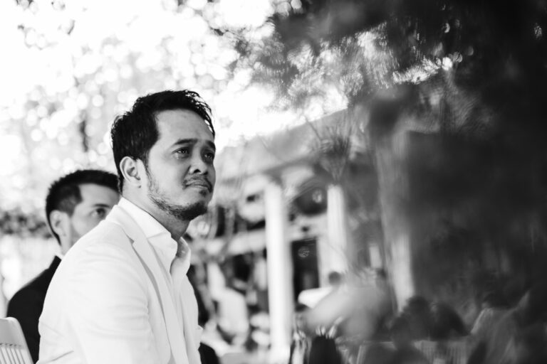 Groom crying whilst listening to a speech during the wedding ceremony.