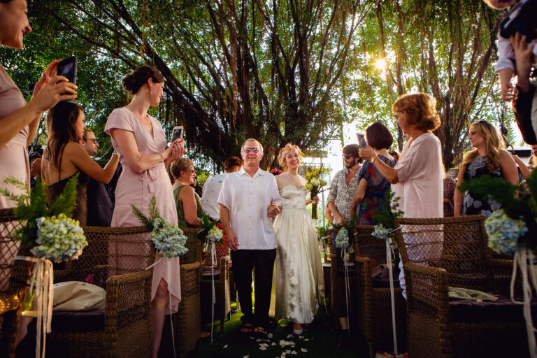 Bride walking down the aisle with her father at the wedding ceremony.