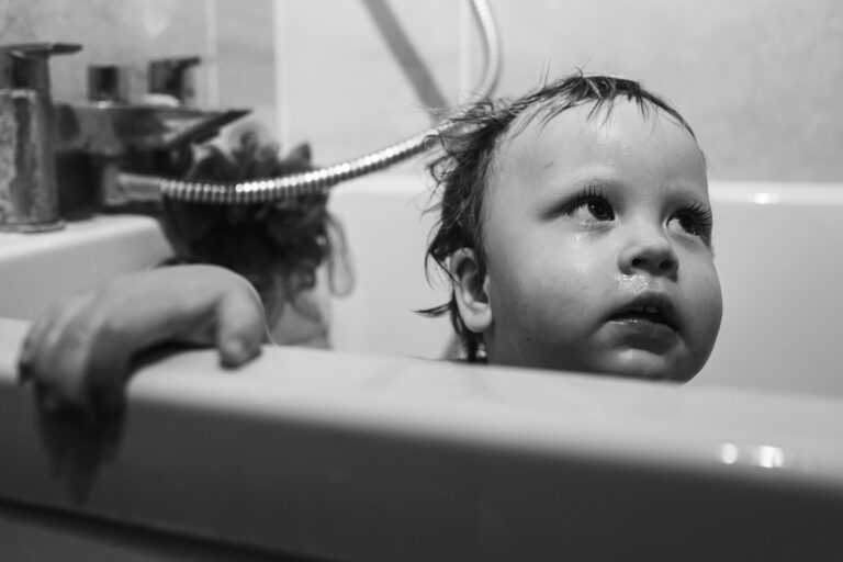 A toddler in the bath during a family photo session
