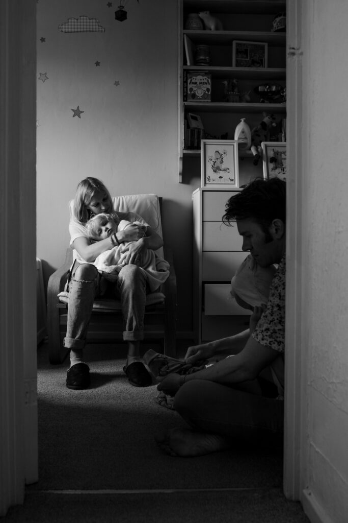 mum and dad getting their young boy twins dressed after a bath during a family photo session