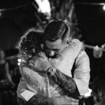 Groom embraces the bride during their first dance.