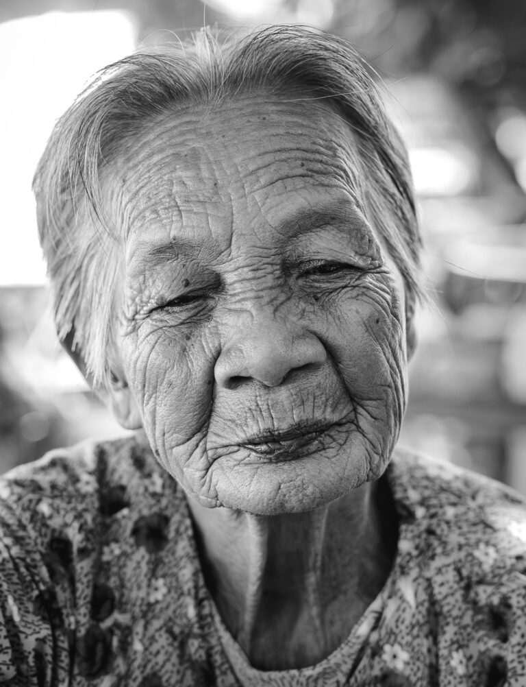Vietnamese woman with short hair poses for a close up portrait