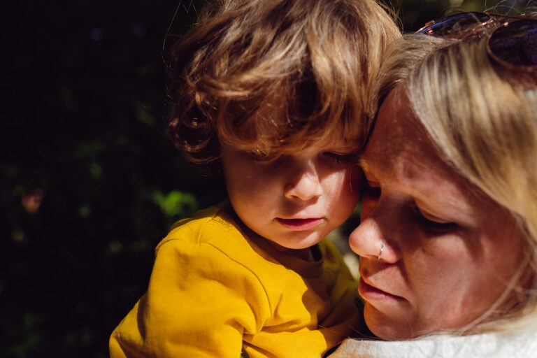 Mum and son with their heads close together during a family photo session.