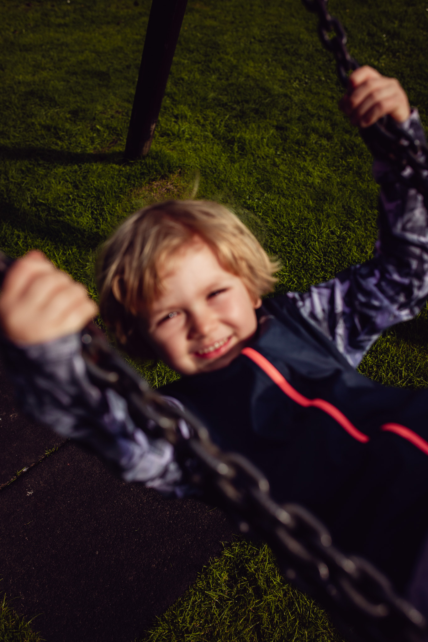 Kai enjoying being on a swing during a family photo session.