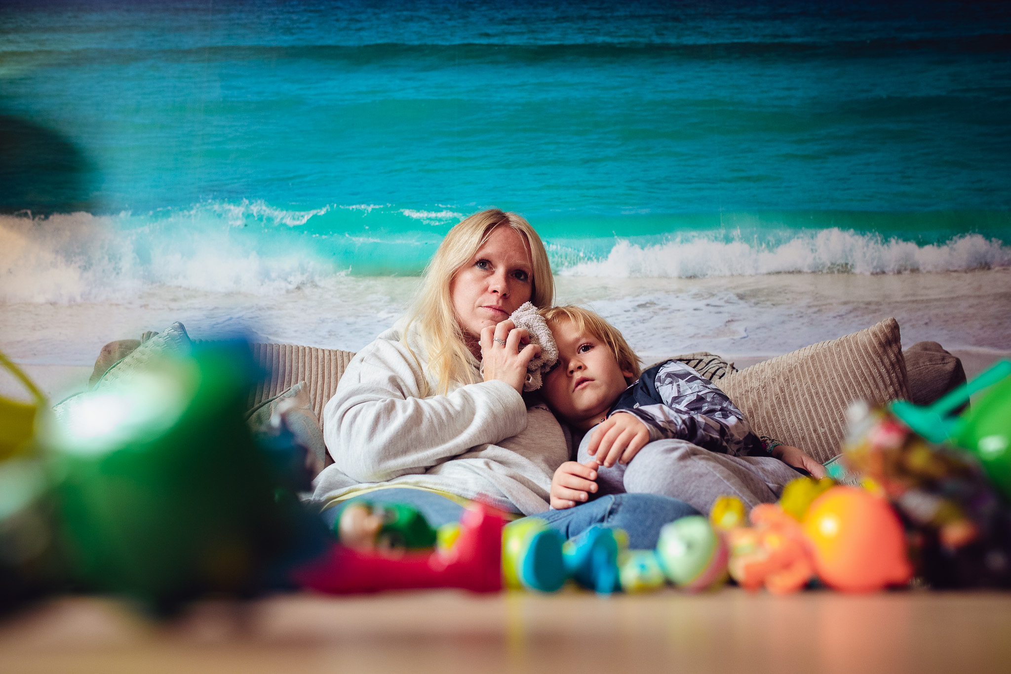 Mum looking after her son and icing his head after a fall during a family photo session