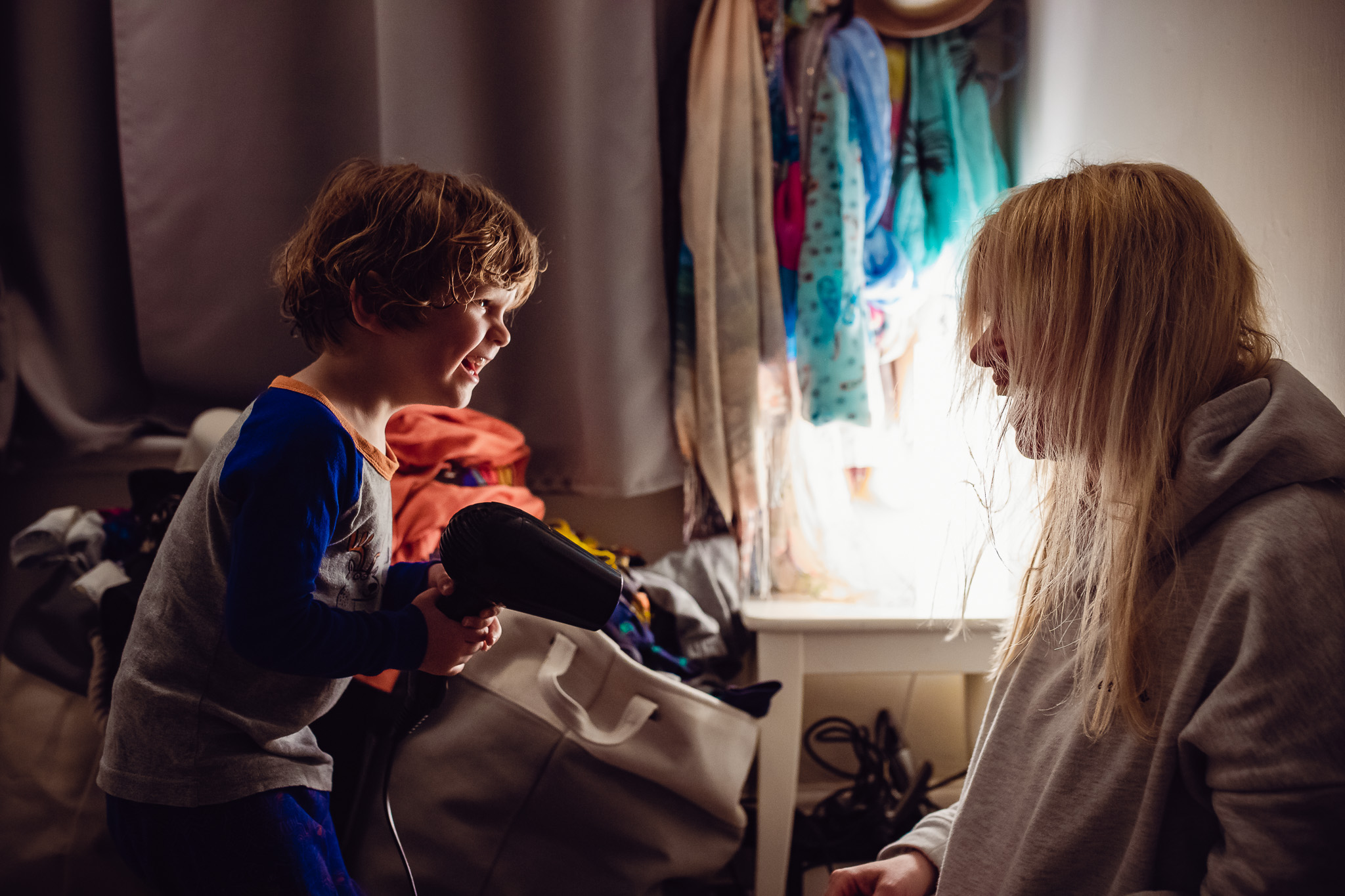 Mum and son are drying each other's hair after bath time during a family photo session.