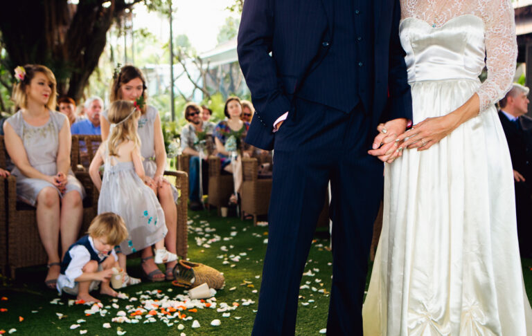 Bride and groom holding hands during wedding ceremony.