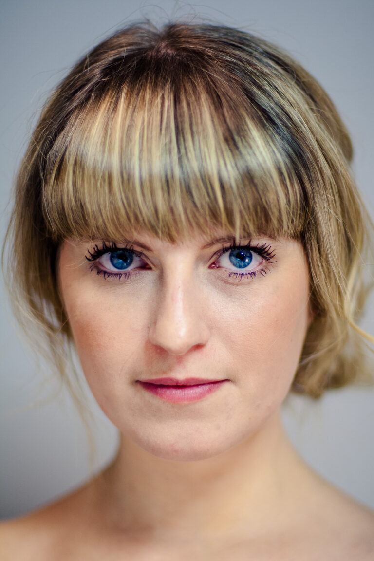 Indoor headshot at Rozewin Photography studio of a young woman on a simple plain background