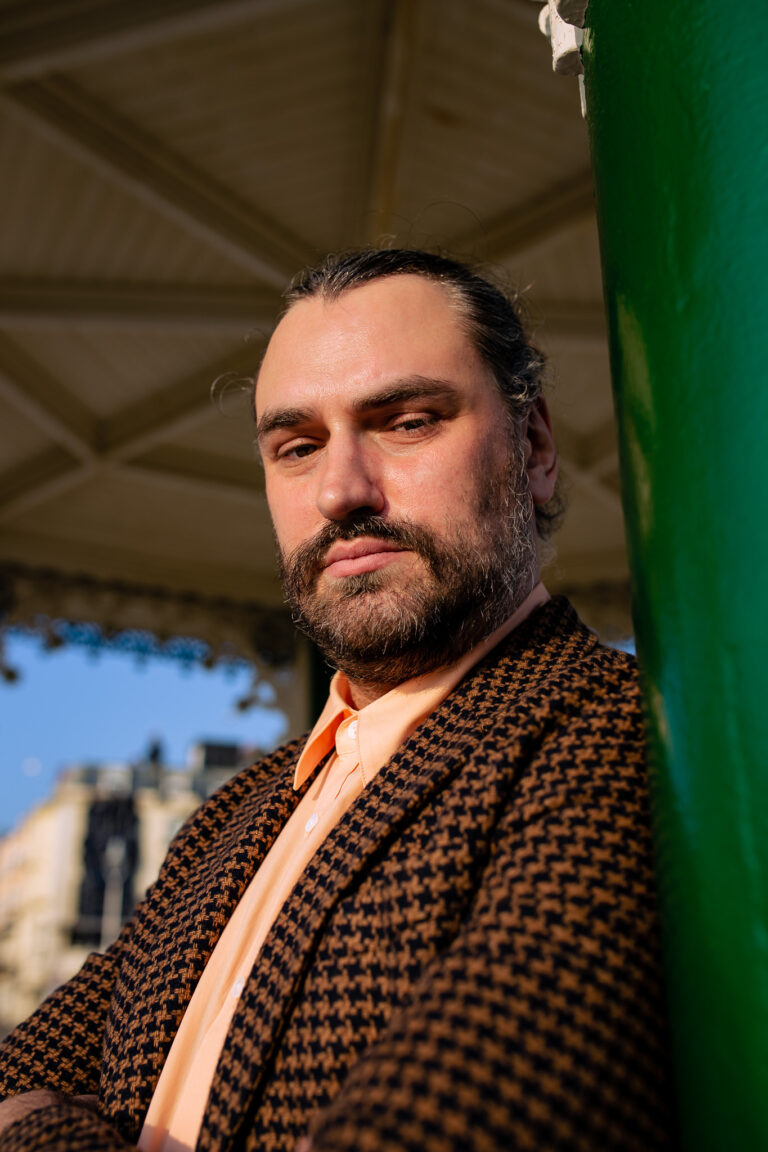 An outdoor headshot of a Brighton wedding officiant at the Brighton bandstand