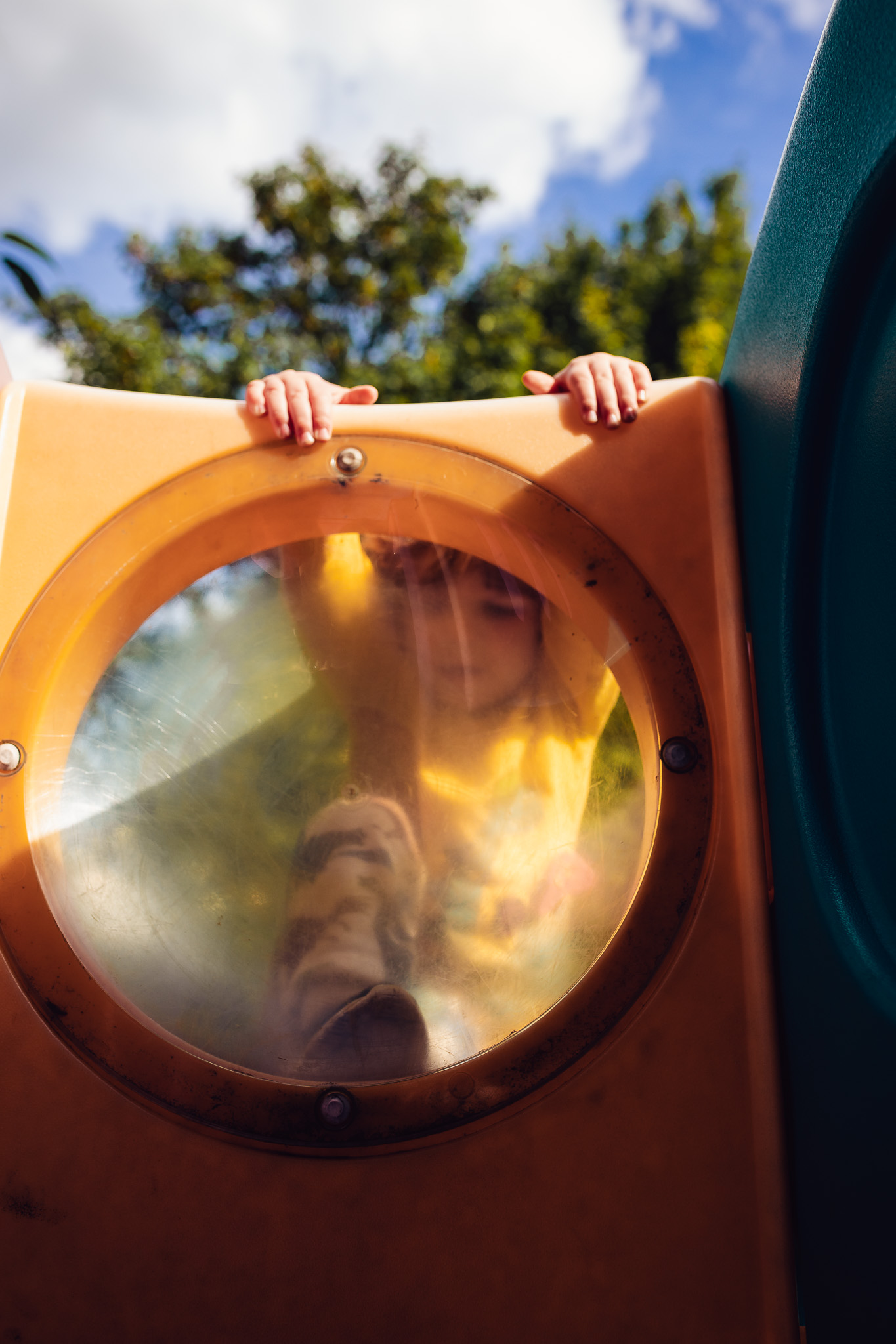 Young boy playing on a climbing frame during a family photo session