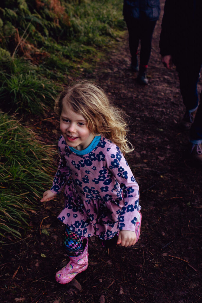 Rosa excitedly running down a muddy forest path on a family holiday in Ireland