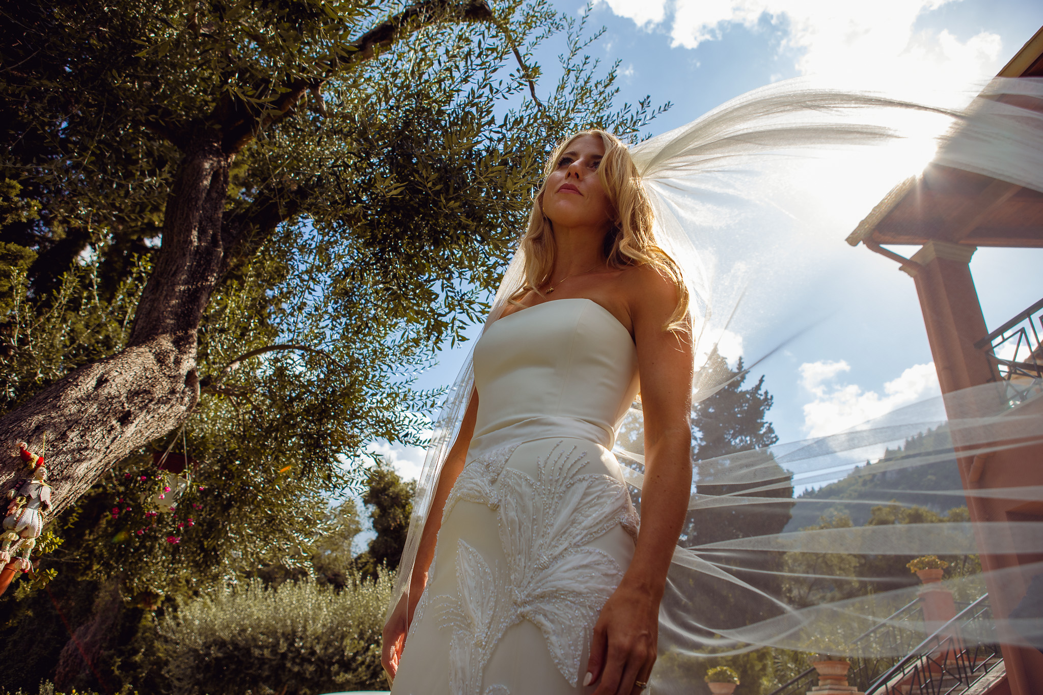 Alice poses for a portrait in her wedding dress and veil in her villa in Crete.