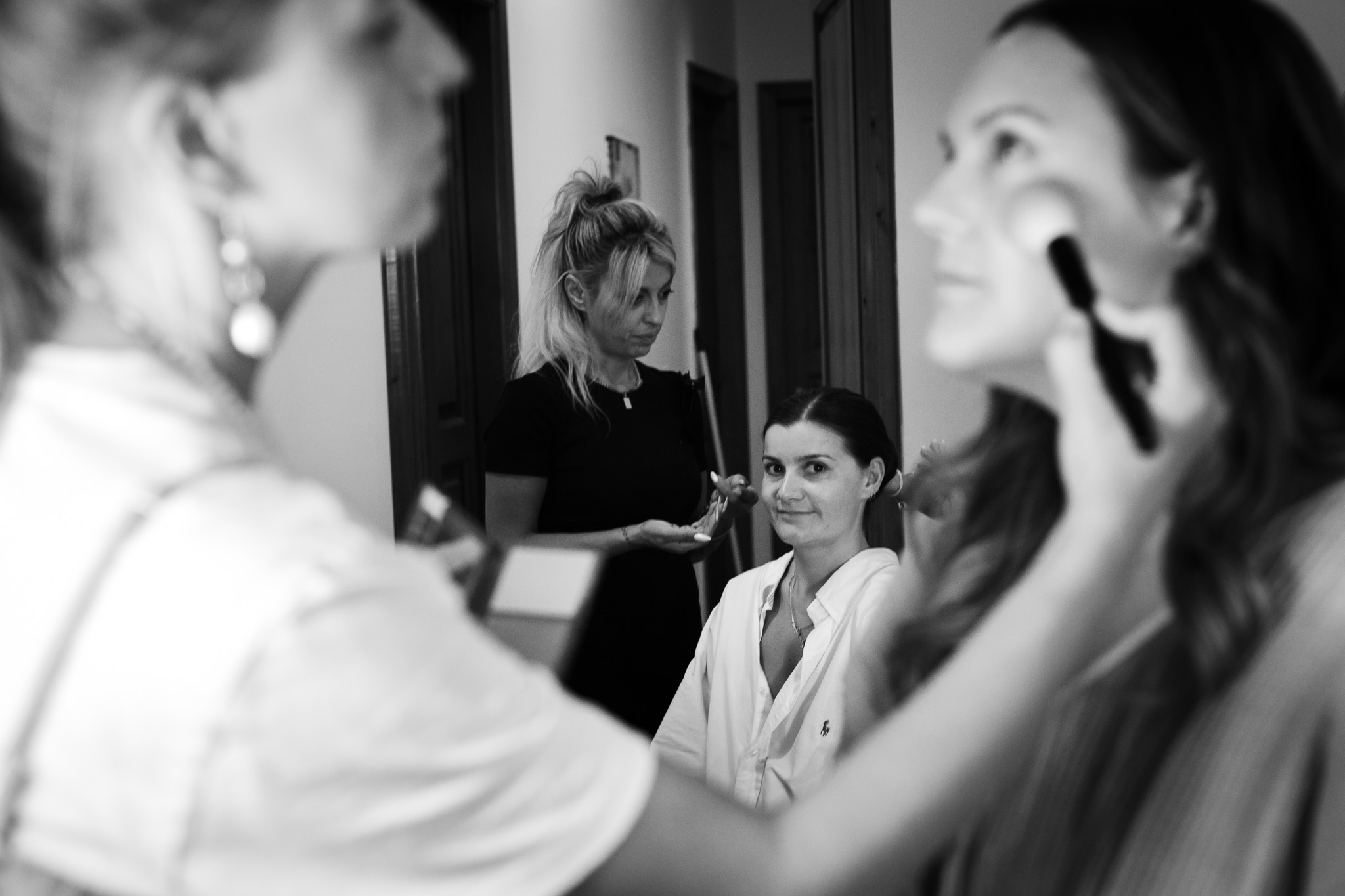 Bridesmaids having their hair and makeup done in preparation for Alice and Tom's Crete destination wedding.