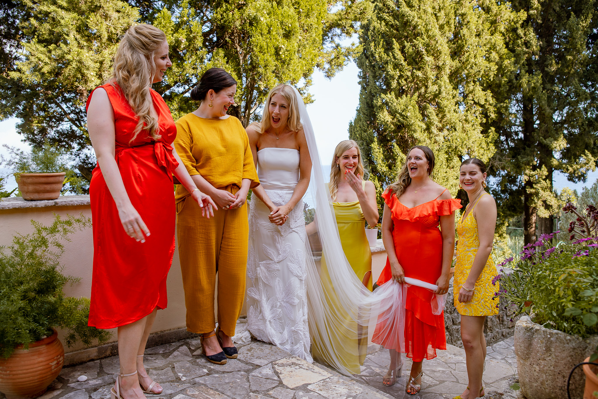 Alice and her bridesmaids are captured in a happy candid moment by Rozewin Photography.