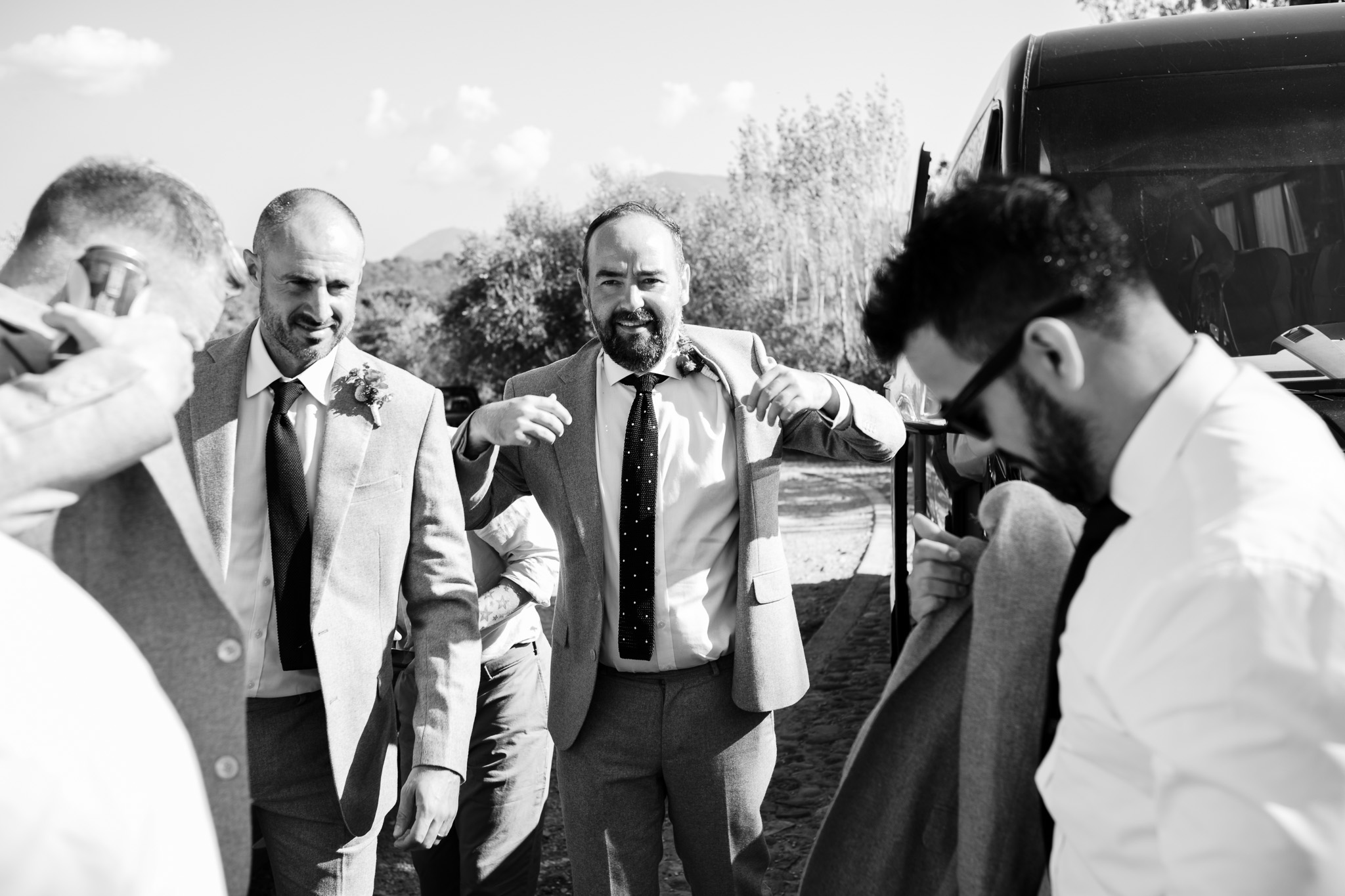 Tom and the groomsmen put their suit jackets on as they arrive at Ambelonas Vineyard.