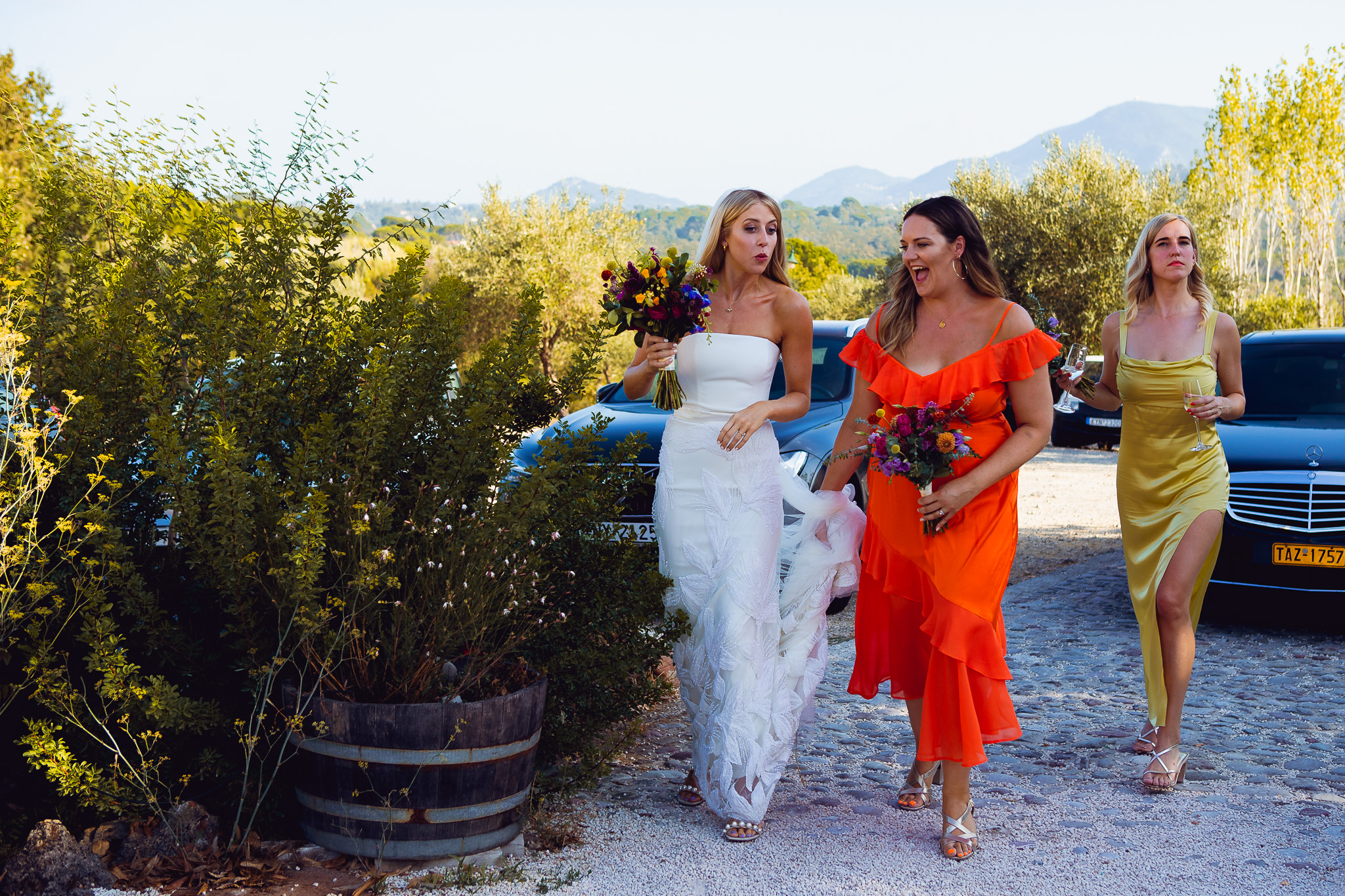 Bride walks into Ambelonas Vineyard with her two bridesmaids before the wedding ceremony