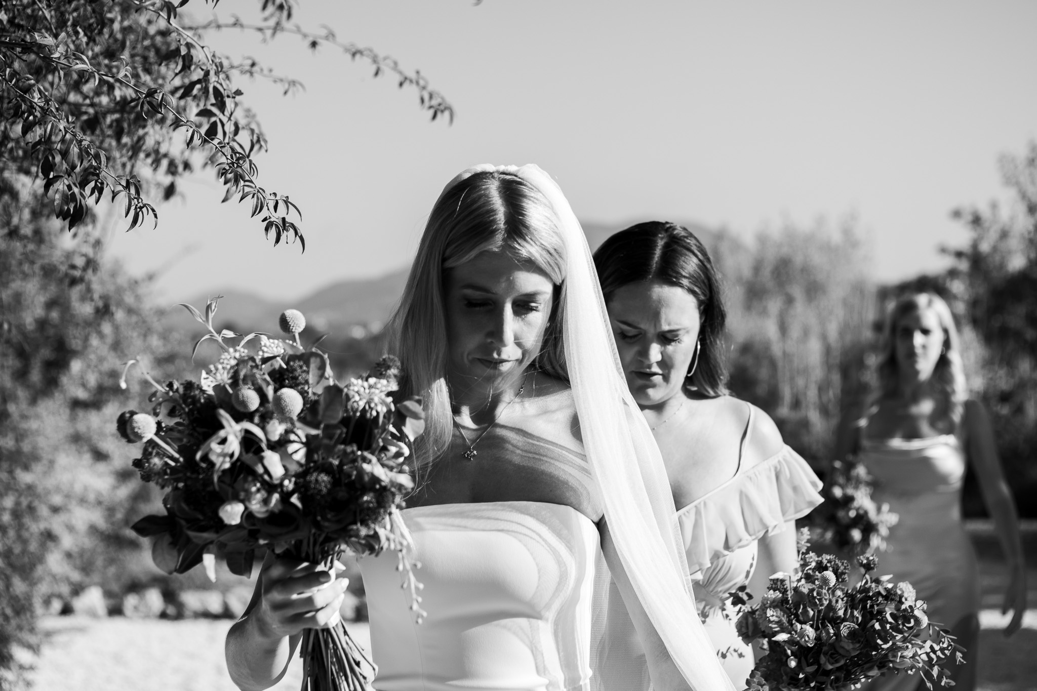 Bride walking into Ambelonas Vineyard with her two bridesmaids before the wedding ceremony