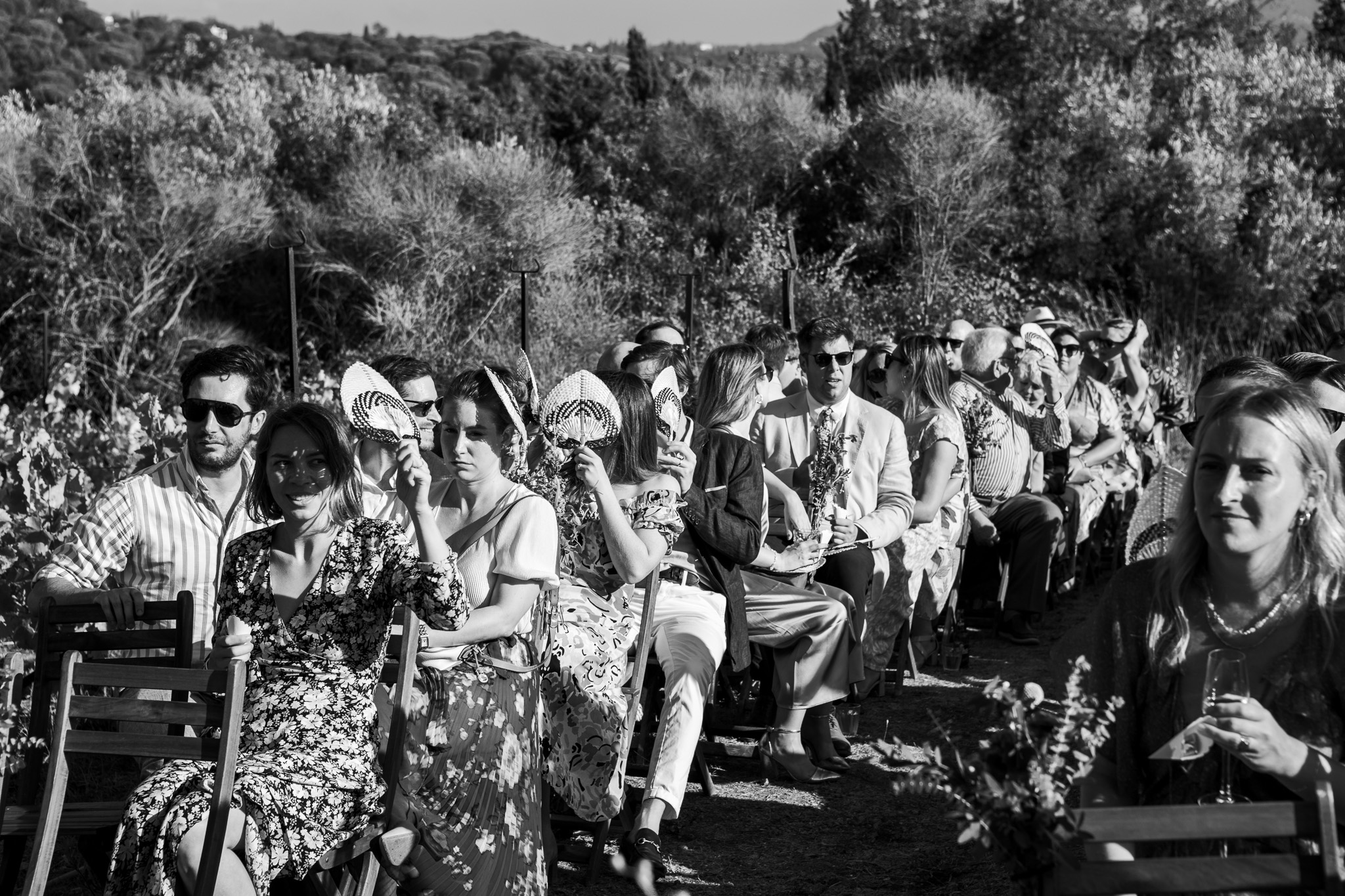 Guests sit and wait for the bride at wedding ceremony in Ambelonas Vineyard, Corfu