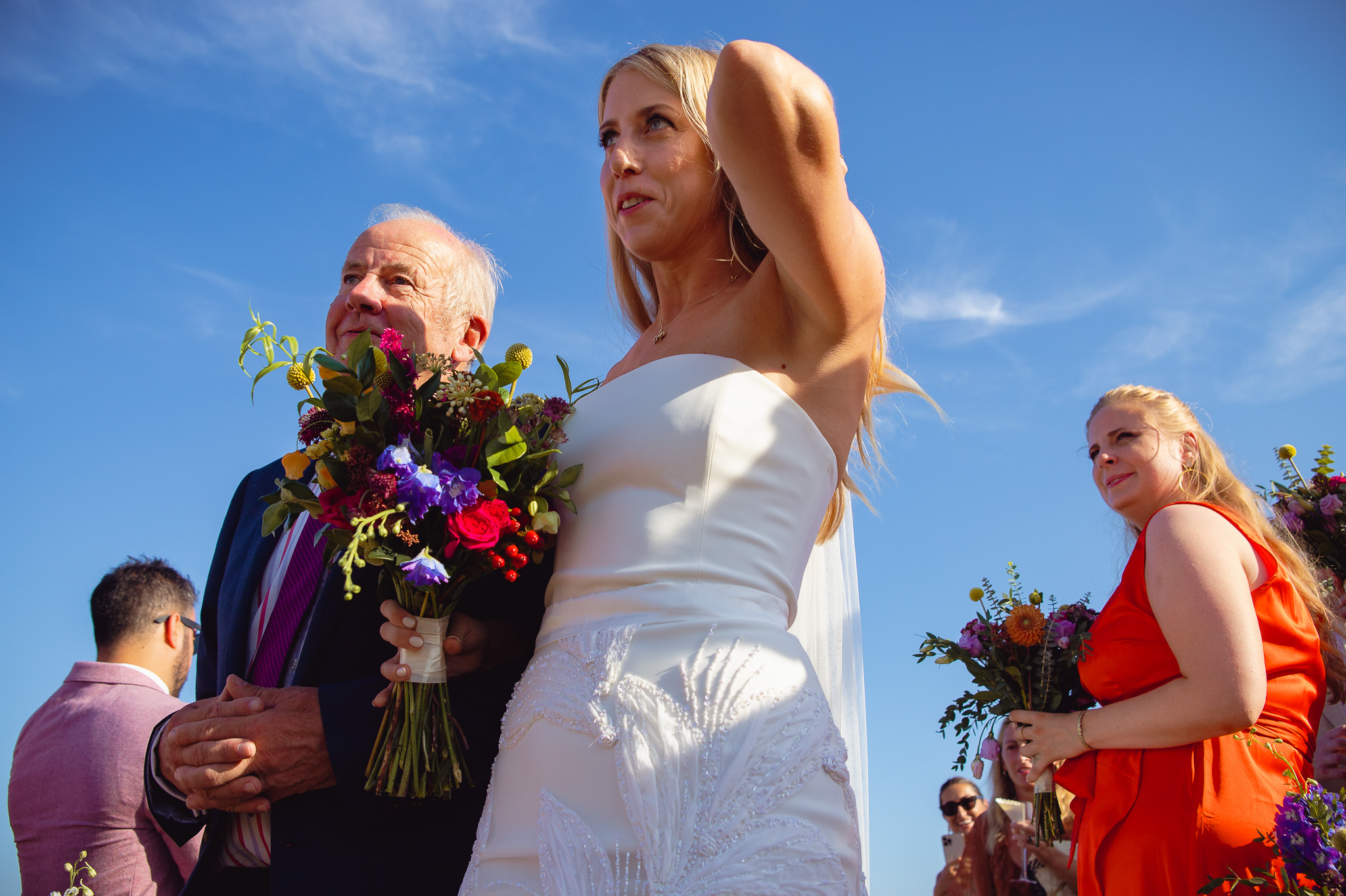 The bride and her dad walk down the aisle at a wedding ceremony at Ambelonas Vineyard, Corfu
