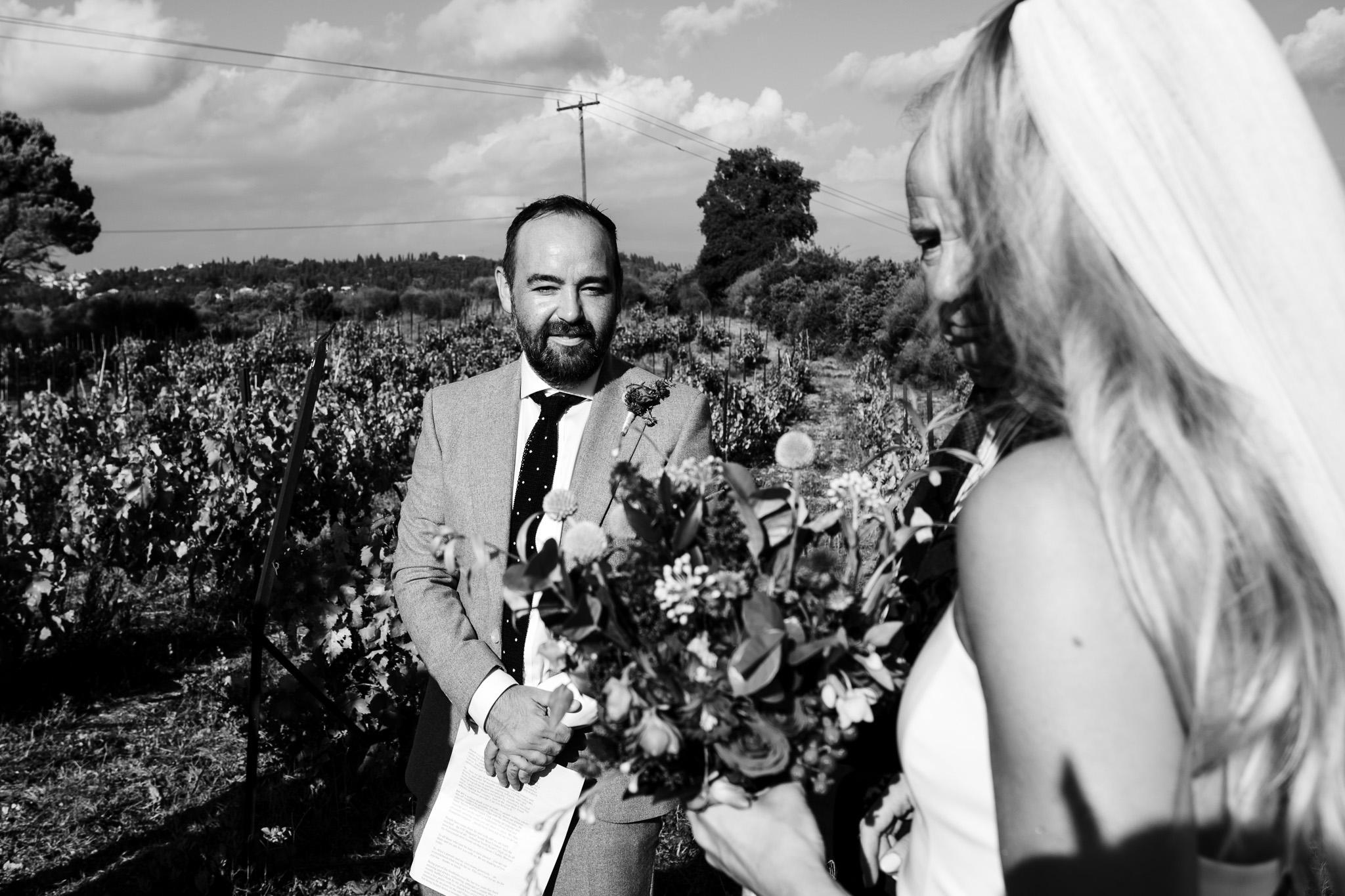 The groom having his first look at the bride as she arrives with her dad at the wedding ceremony