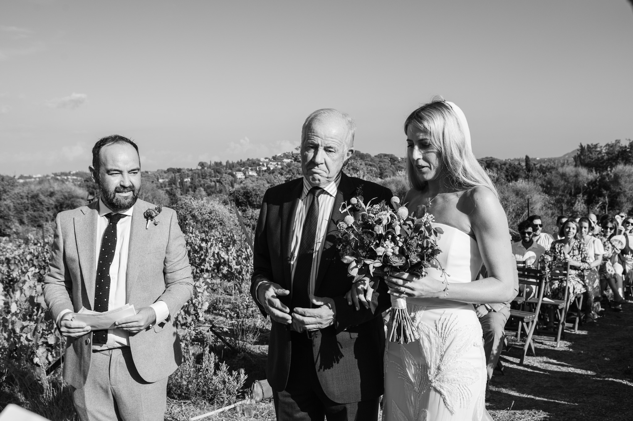 The bride and her dad arrive to the groom at a wedding ceremony in Ambelonas Vineyard, Corfu