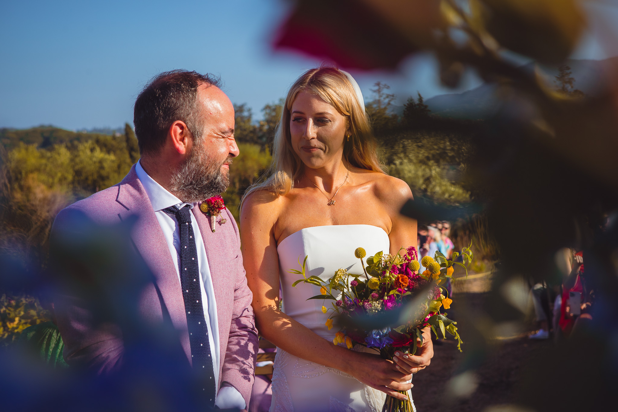 The bride and groom look at each other as they wait for their wedding ceremony to start