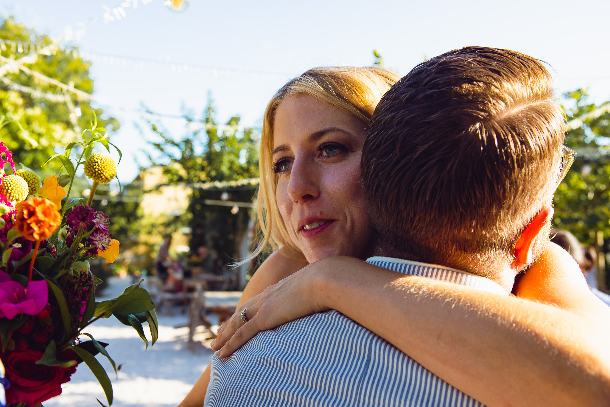 The bride smiles and hugs a guest after her wedding ceremomy at Ambelonas Vineyard, Corfu