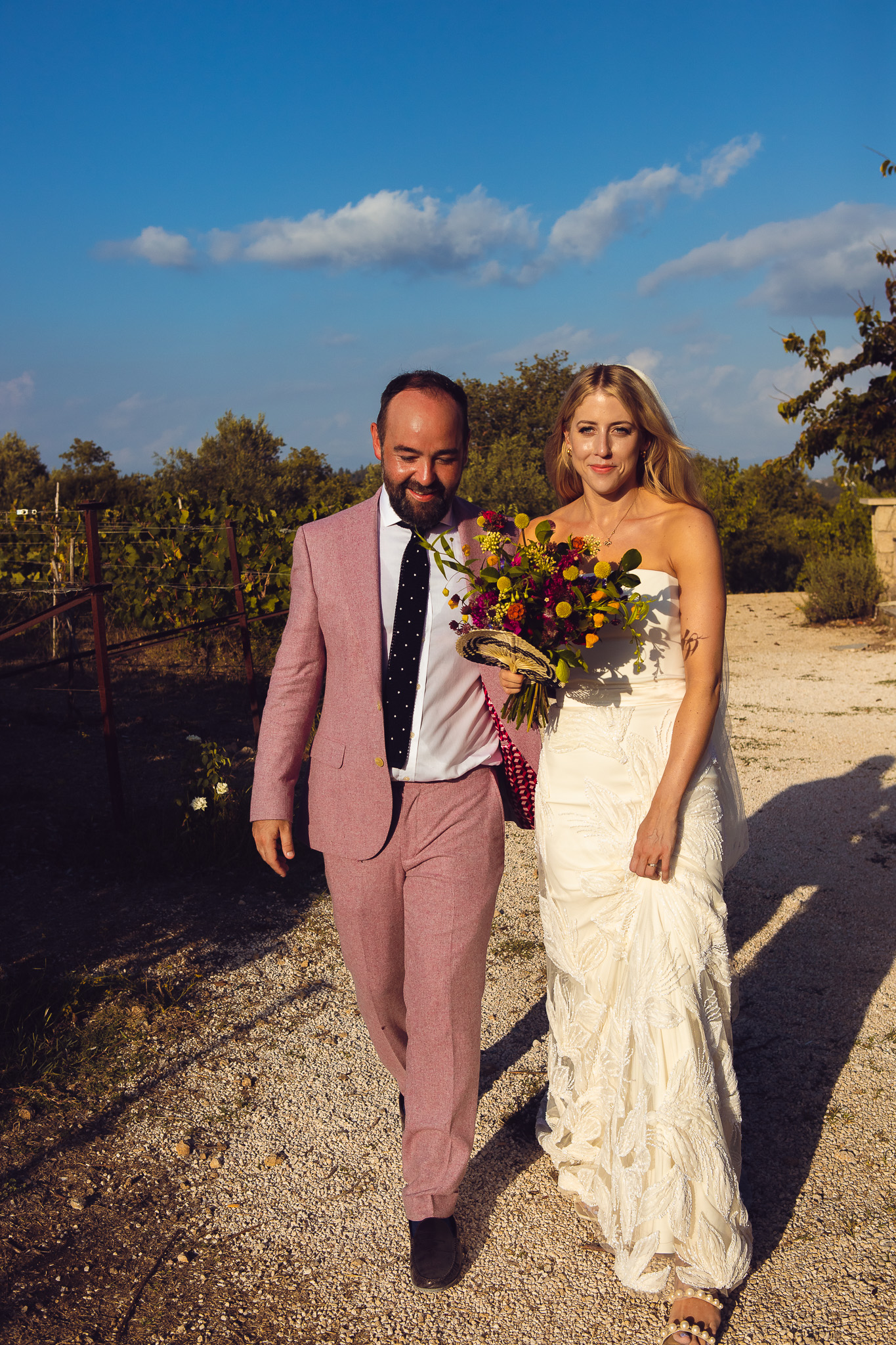 Alice and Tom walk together into the setting sun for a couples session at their wedding at Ambelonas Vineyard, Corfu