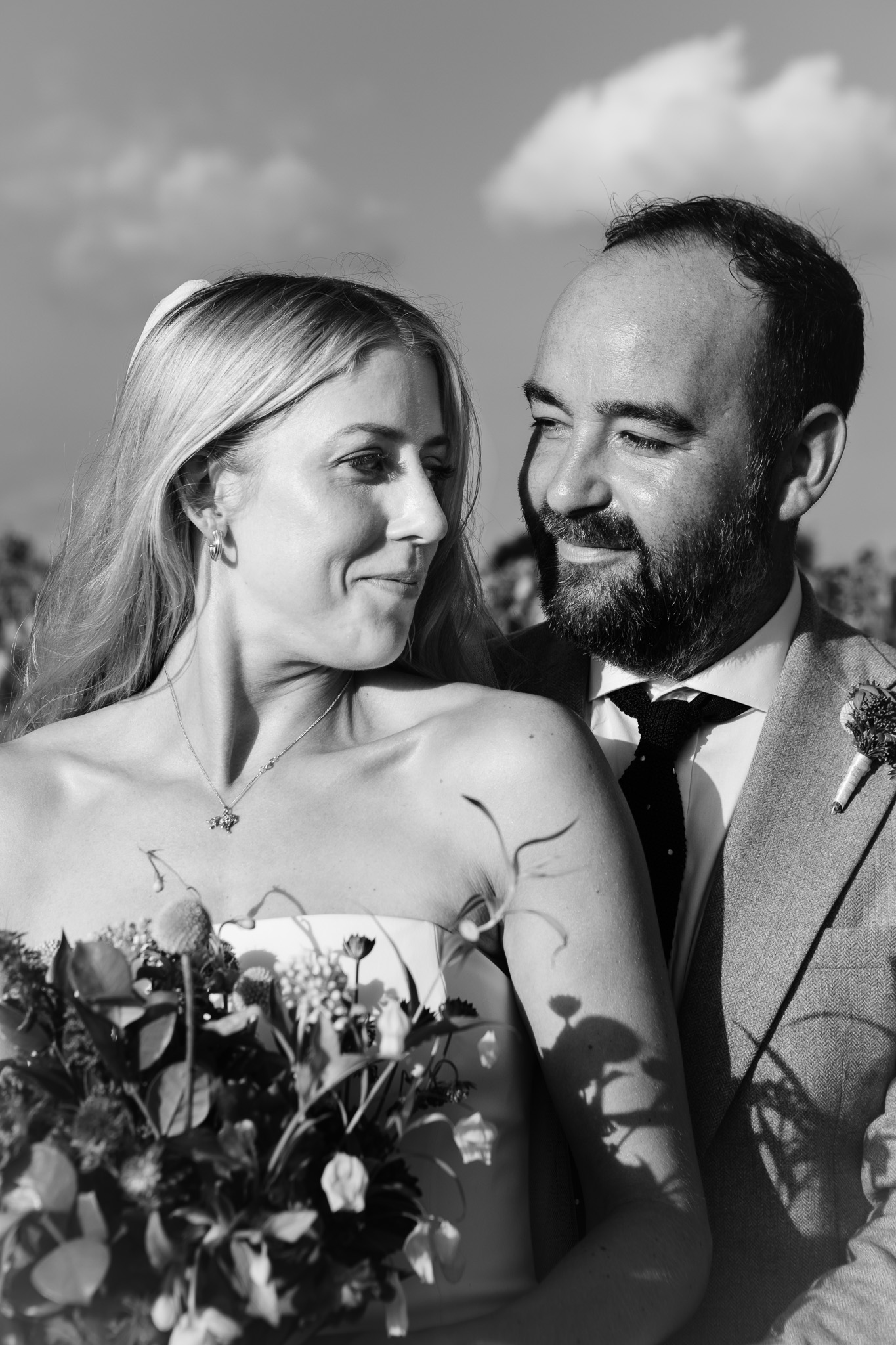 Alice and Tom look and smile at each other during a couples photo session during their wedding day