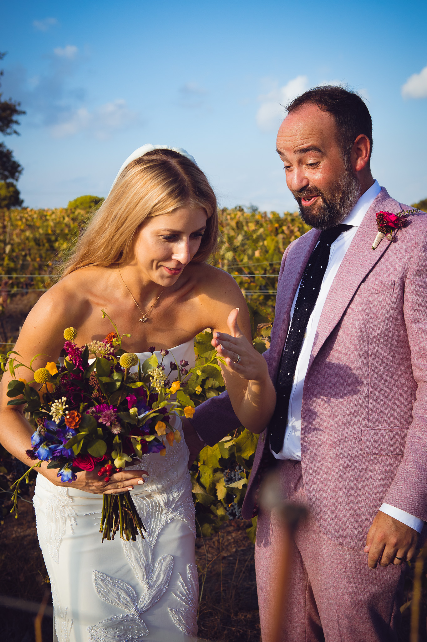 Alice does the robot dance for Tom in the vineyard during a couples photo session