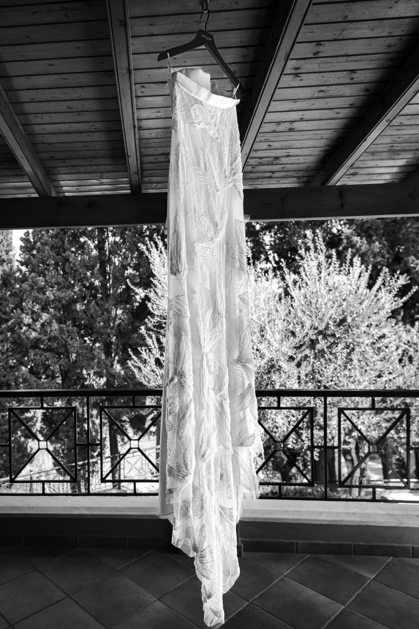 A Halfpenny wedding dress and skirt hanging up from the ceiling at a villa in Crete.
