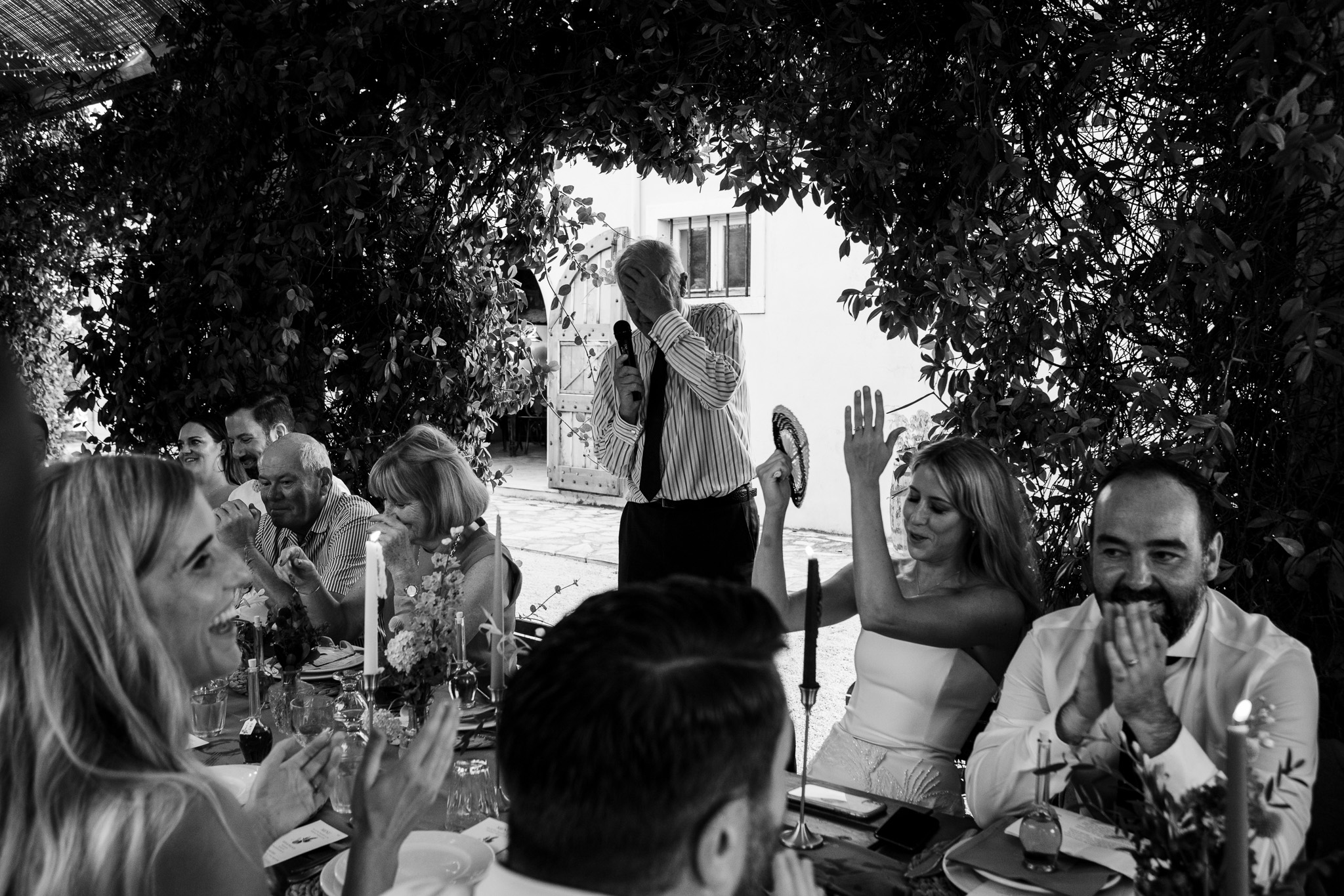 Father of the bride mid-speech with hand on head whilst guests laugh at Ambelonas Vineyard, Corfu