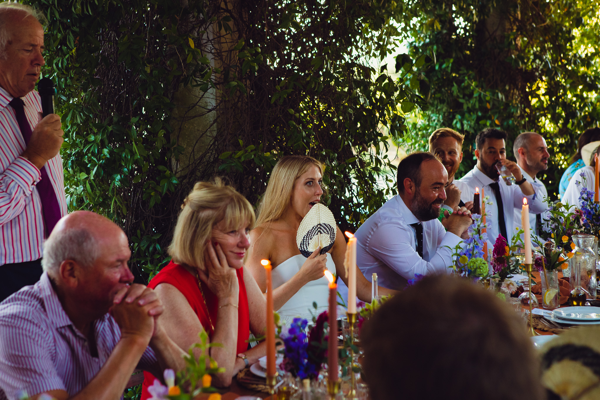 Bride reacts in shock to her father's speech during the wedding dinner