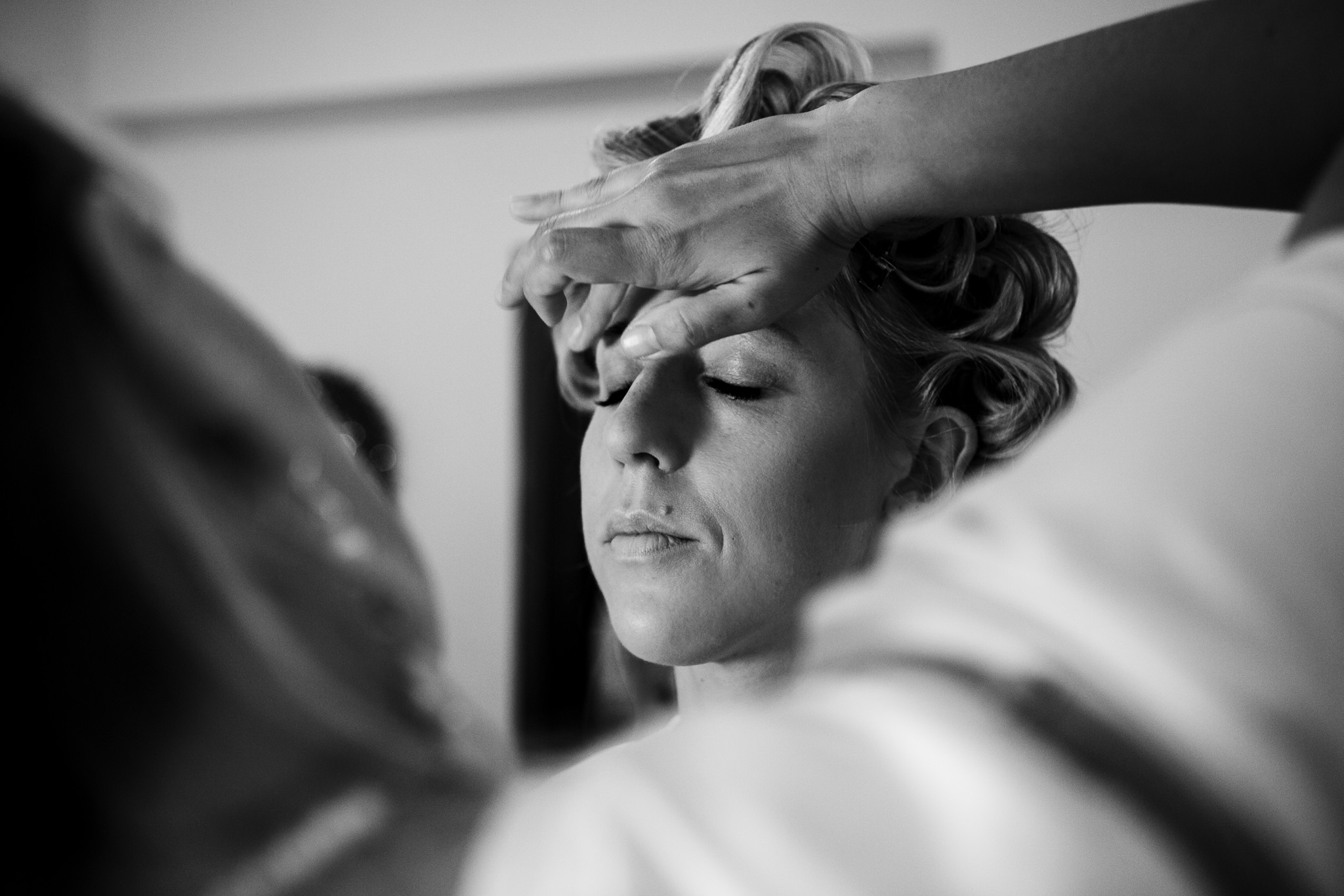 Alice getting her eyeshadow applied in preparation for her wedding day.