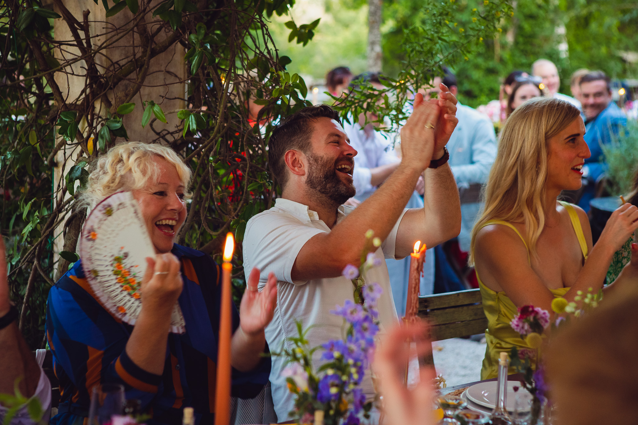 Guests clap and laugh during wedding speeches in Ambelonas Vineyard, Corfu