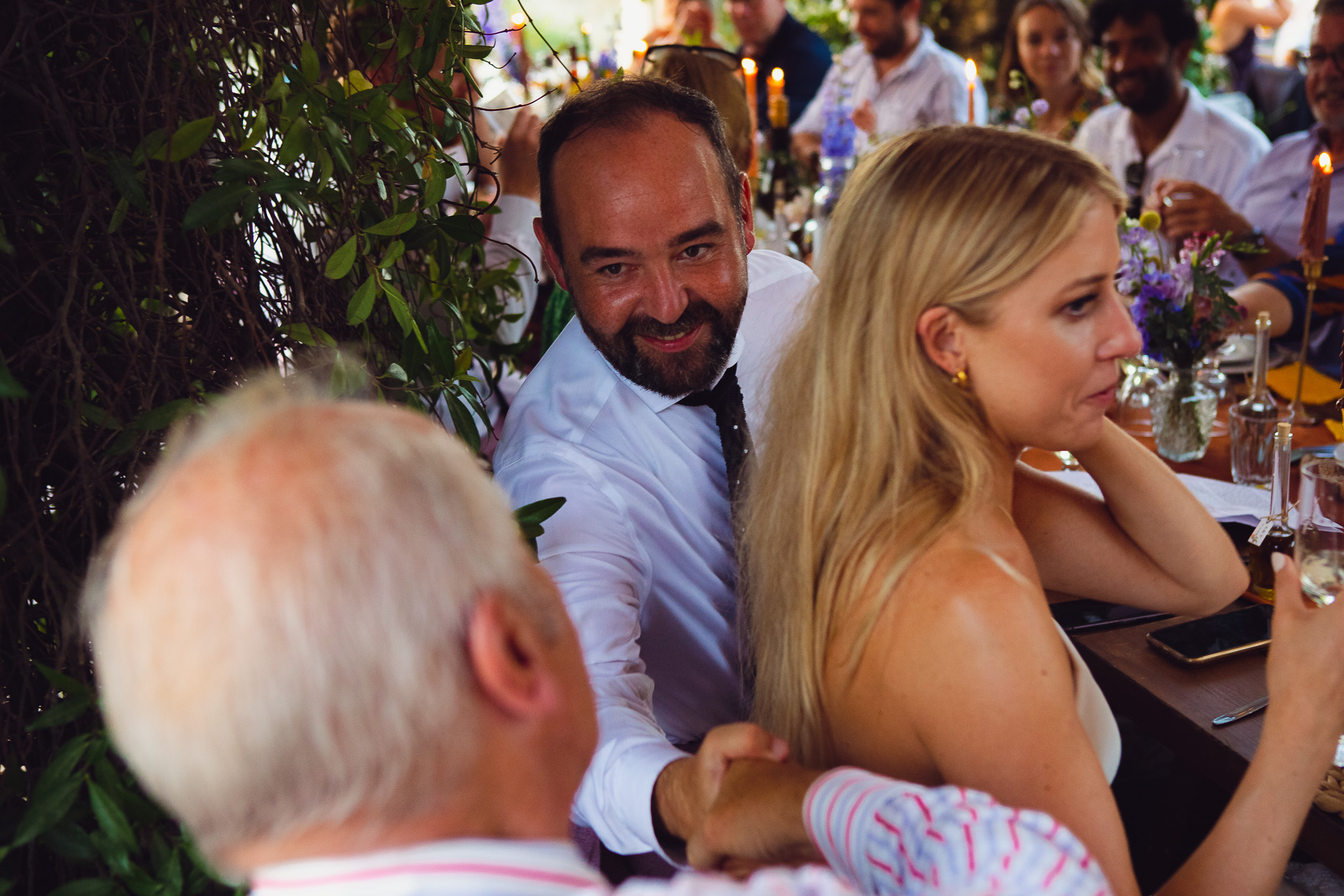 Groom shakes father of the brides hand at the wedding dinner following wedding speeches