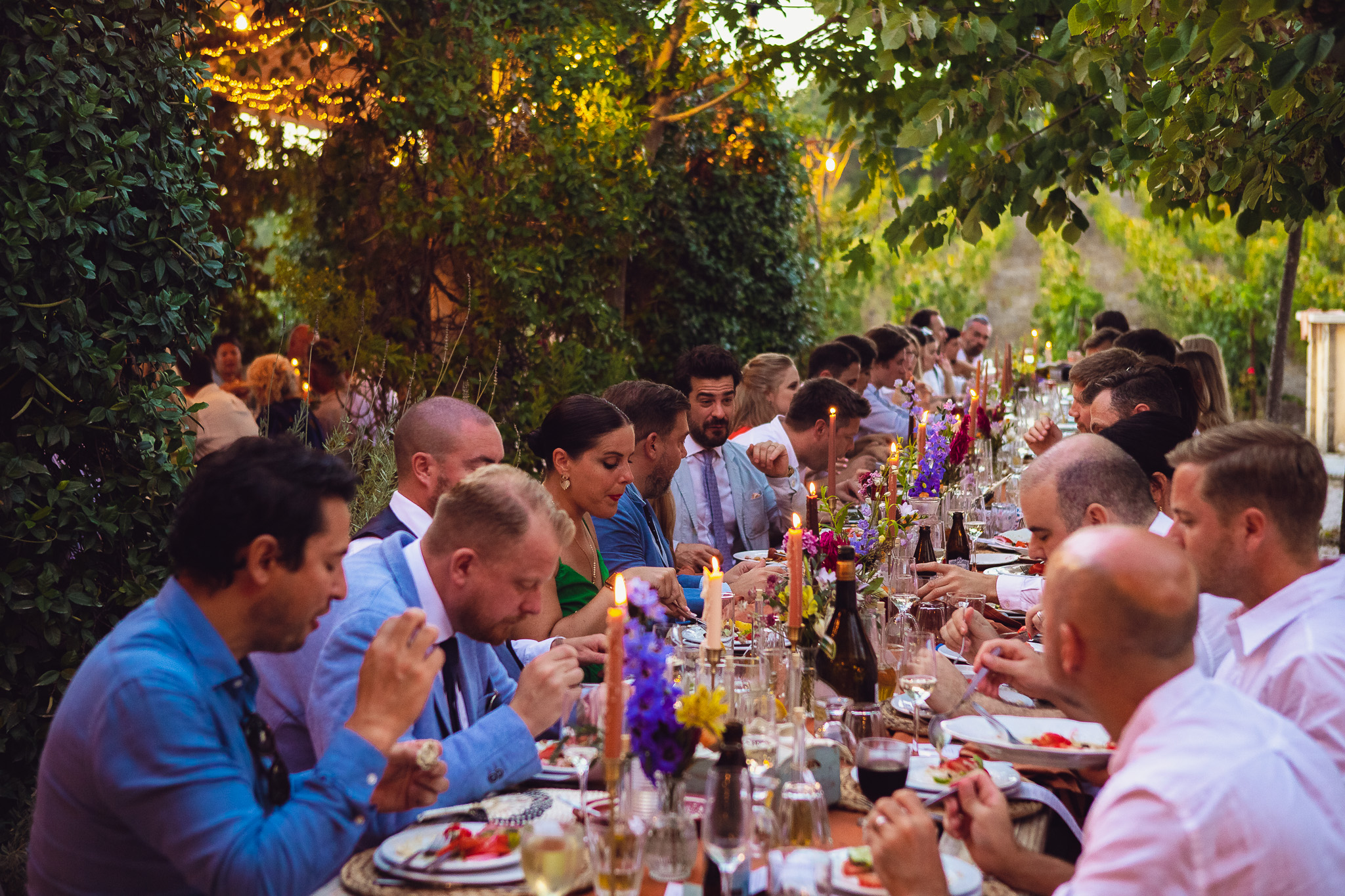 Wedding guests eating their dinner at a beautiful destination wedding in Corfu at Ambelonas Vineyard