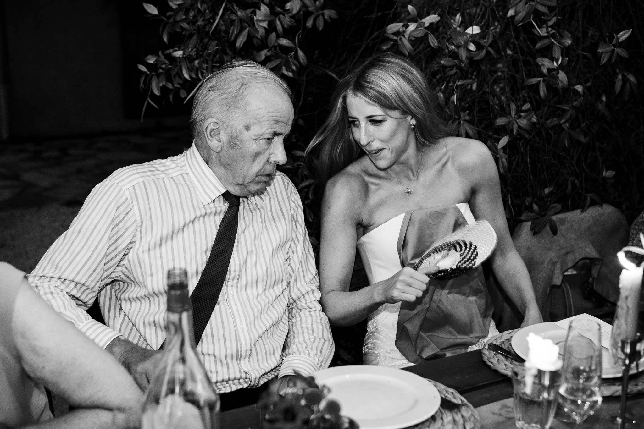 Bride and her father laugh and chat during the wedding dinner