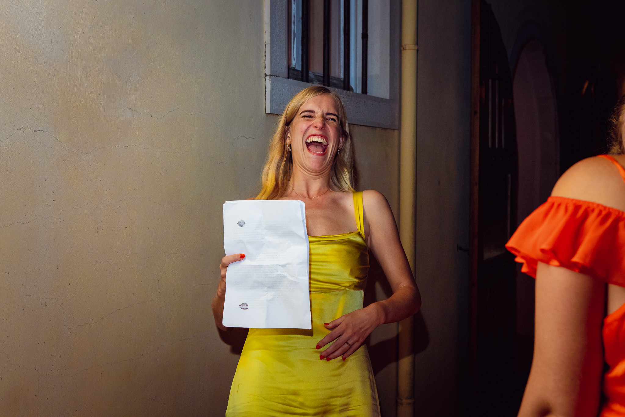 Bridesmaid laughs as she practices her wedding speech