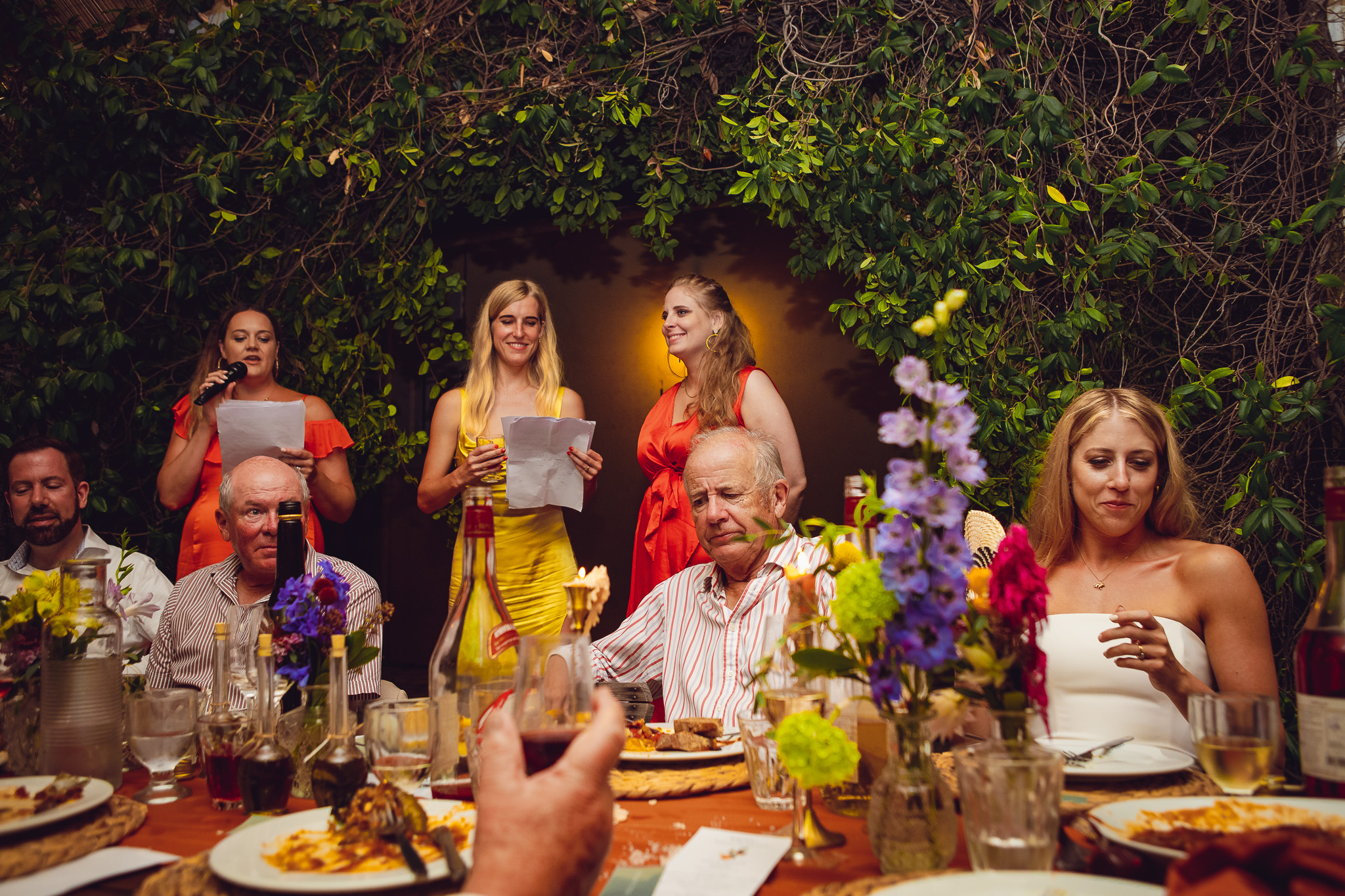 Three bridesmaids stand a give wedding speech during a wedding dinner at Ambelonas Vineyard, Corfu