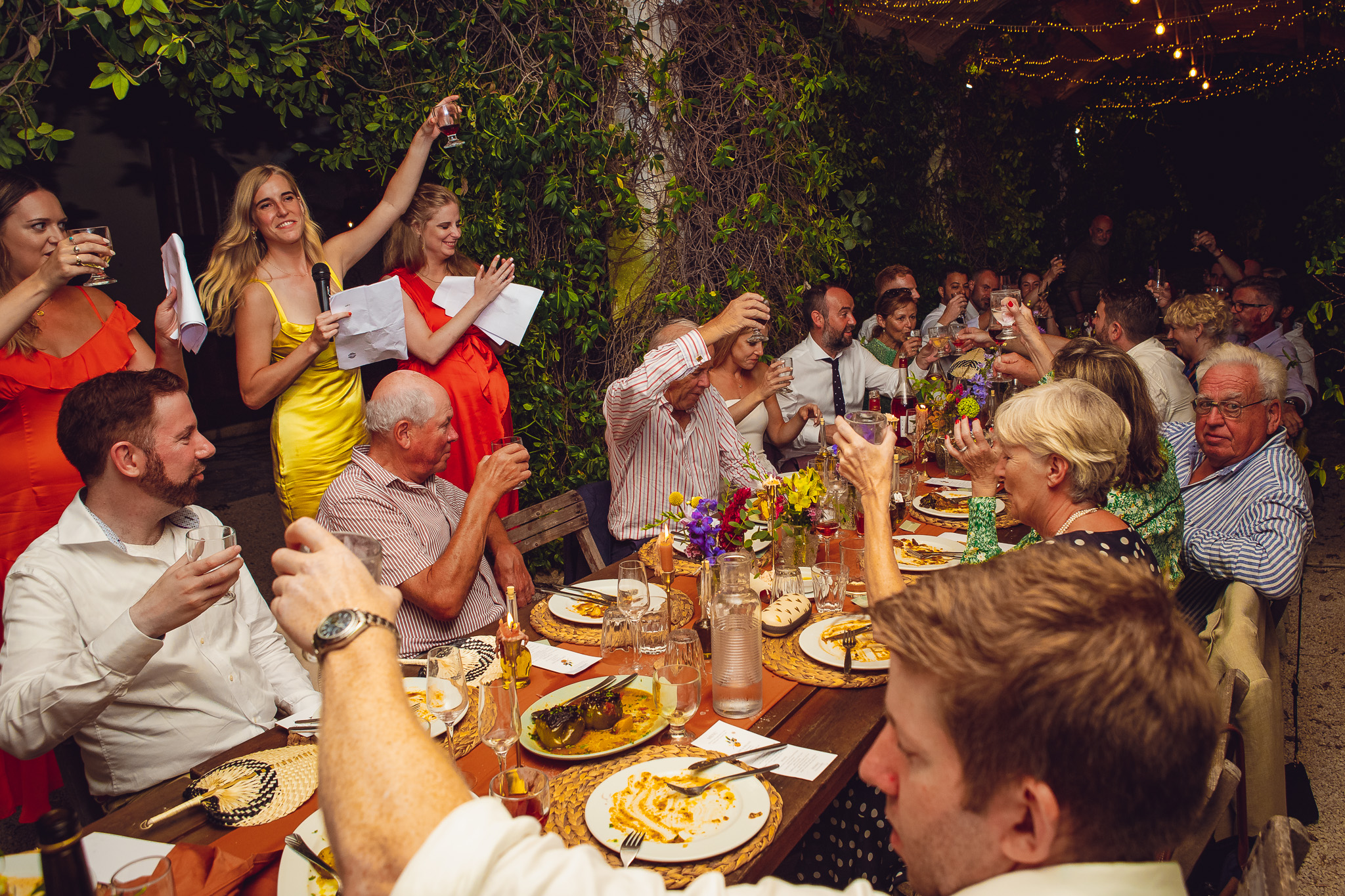 Bridesmaids toast the guests after giving their speech during a wedding dinner