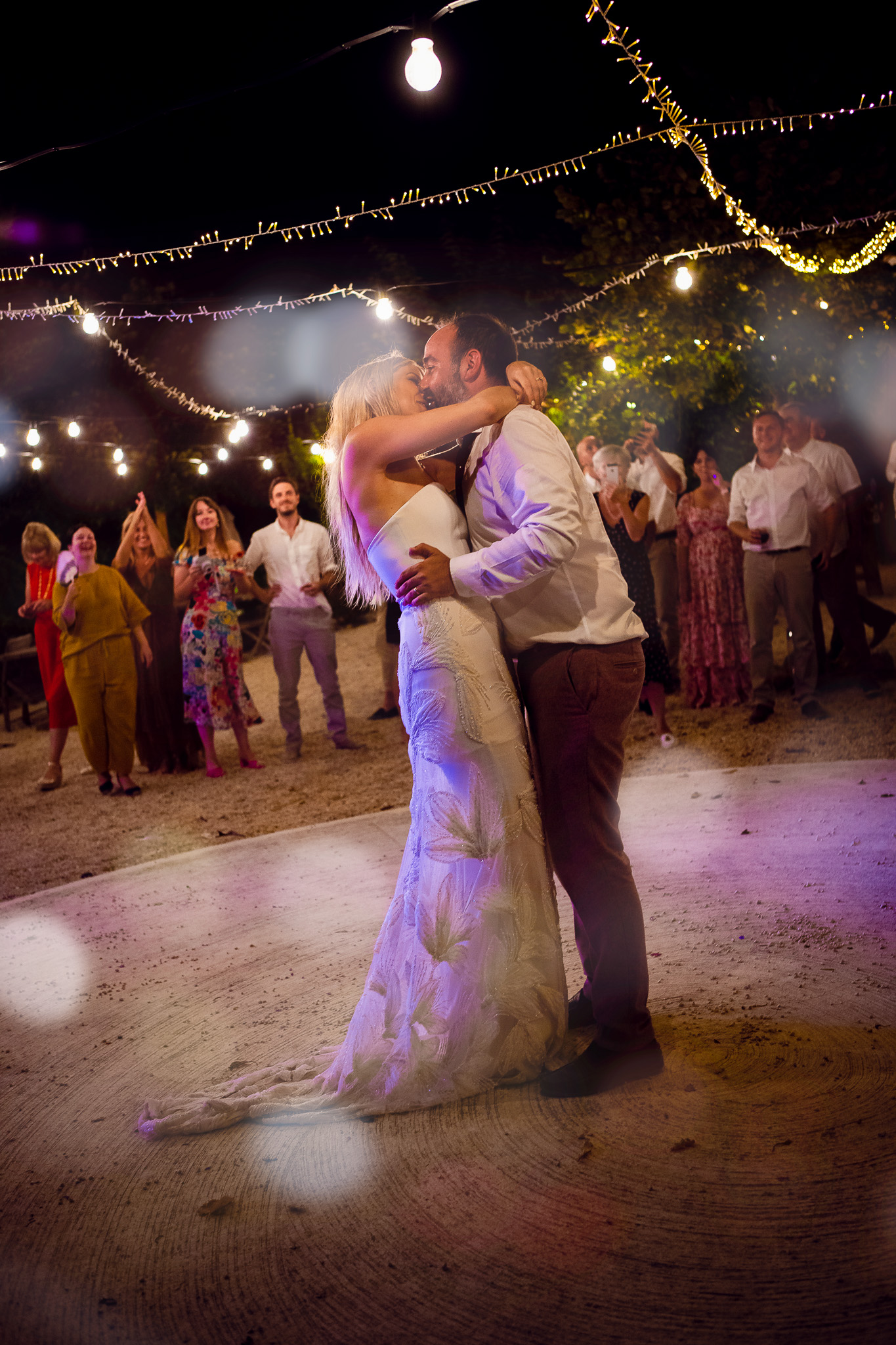 Bride and groom kiss during their first dance at their destination wedding in Corfu