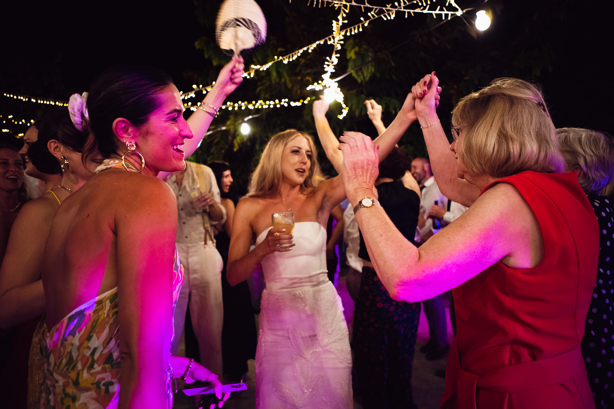 The bride dances with her mum and guests at the wedding reception