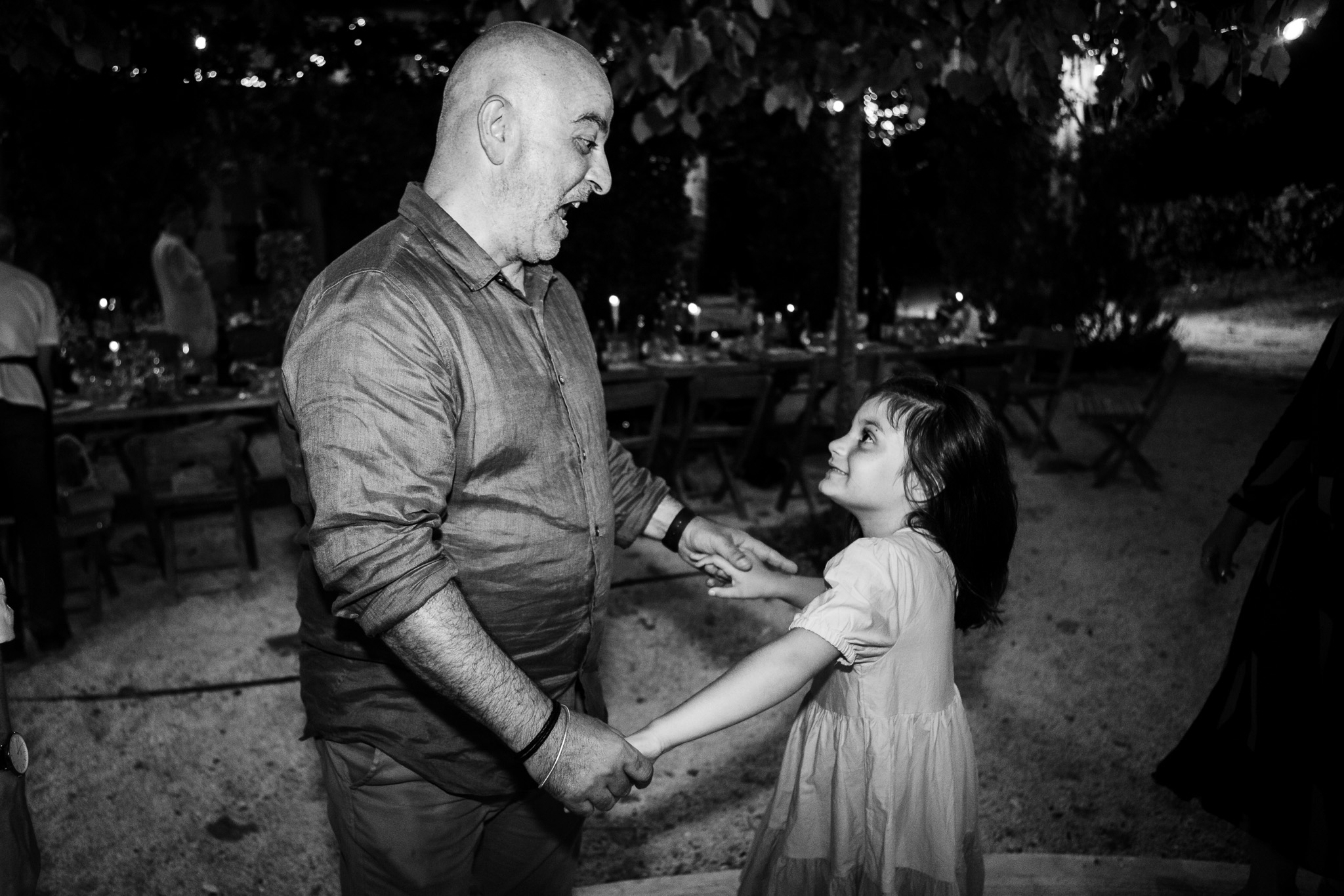 Guest dances with his daughter at a wedding reception in Ambelonas Vineyard, Corfu