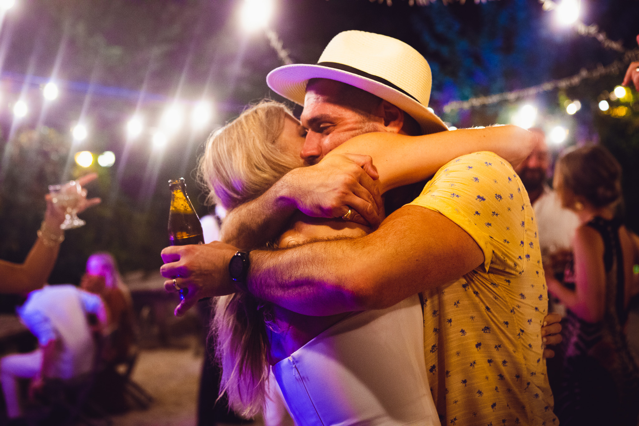 Bride hugs a guest on the dance floor at her wedding reception