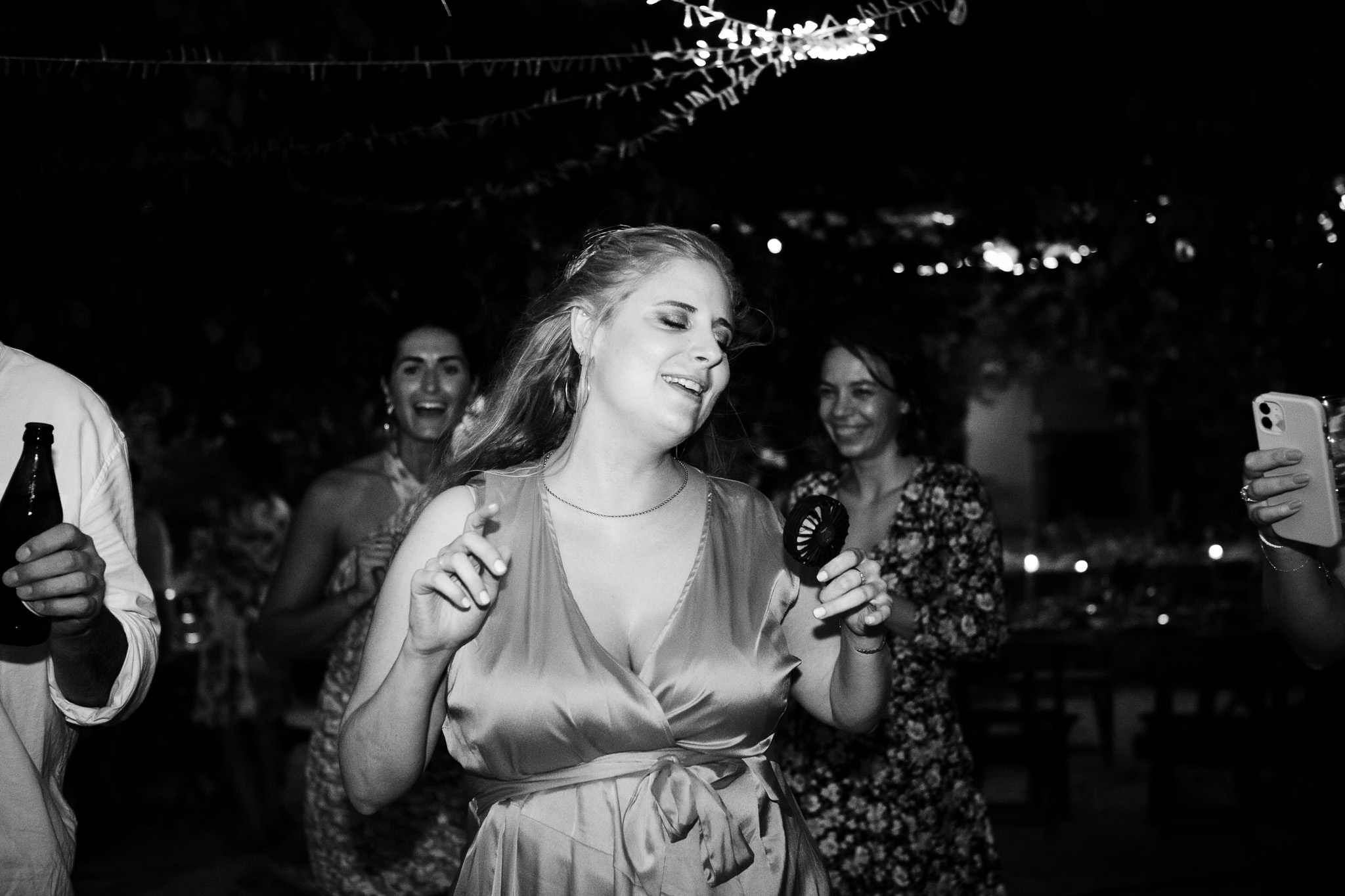 Bridesmaid enjoys the music as she dances at a wedding reception