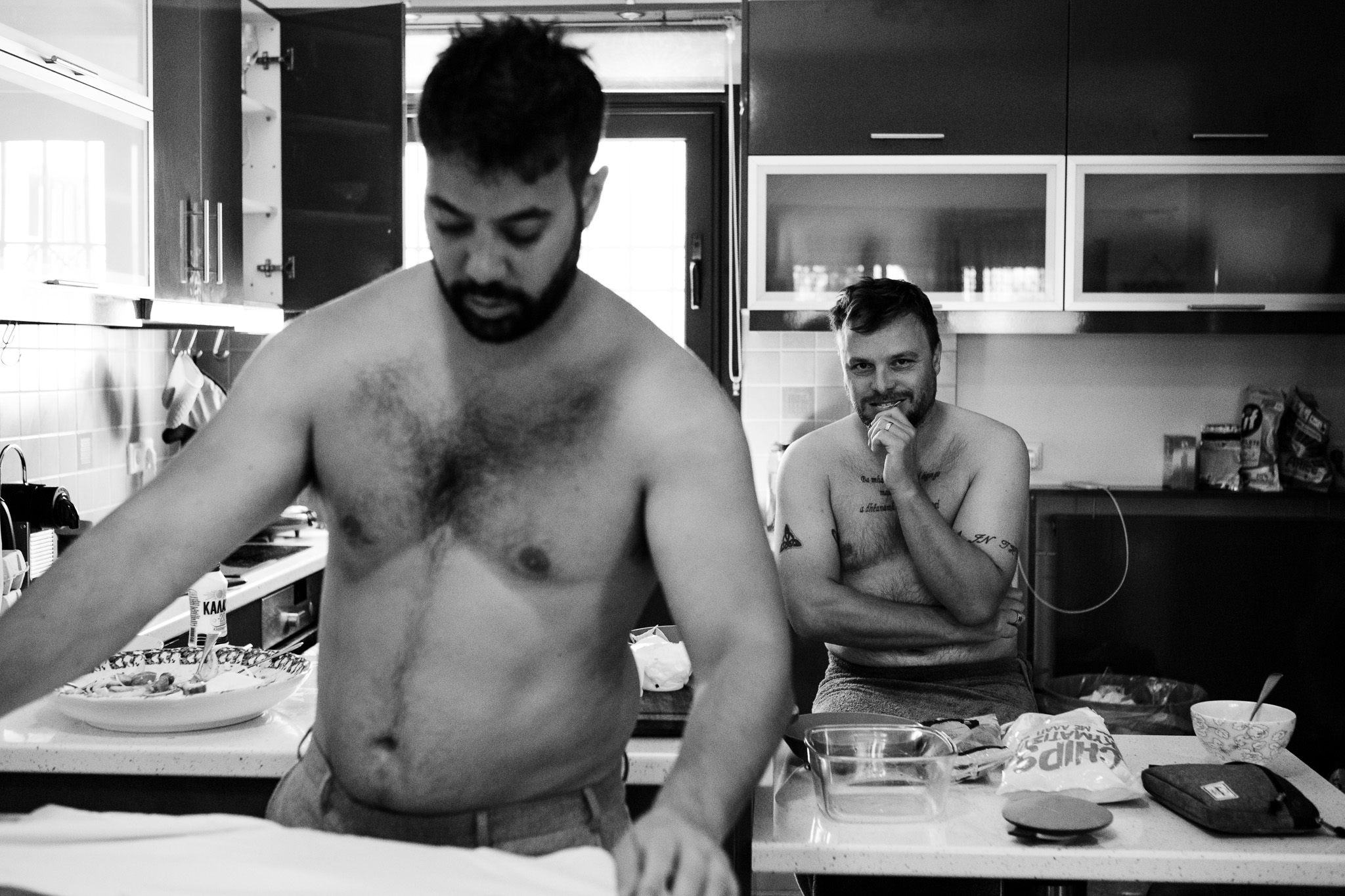 Groomsmen getting ready in the kitchen for their friend's wedding day.