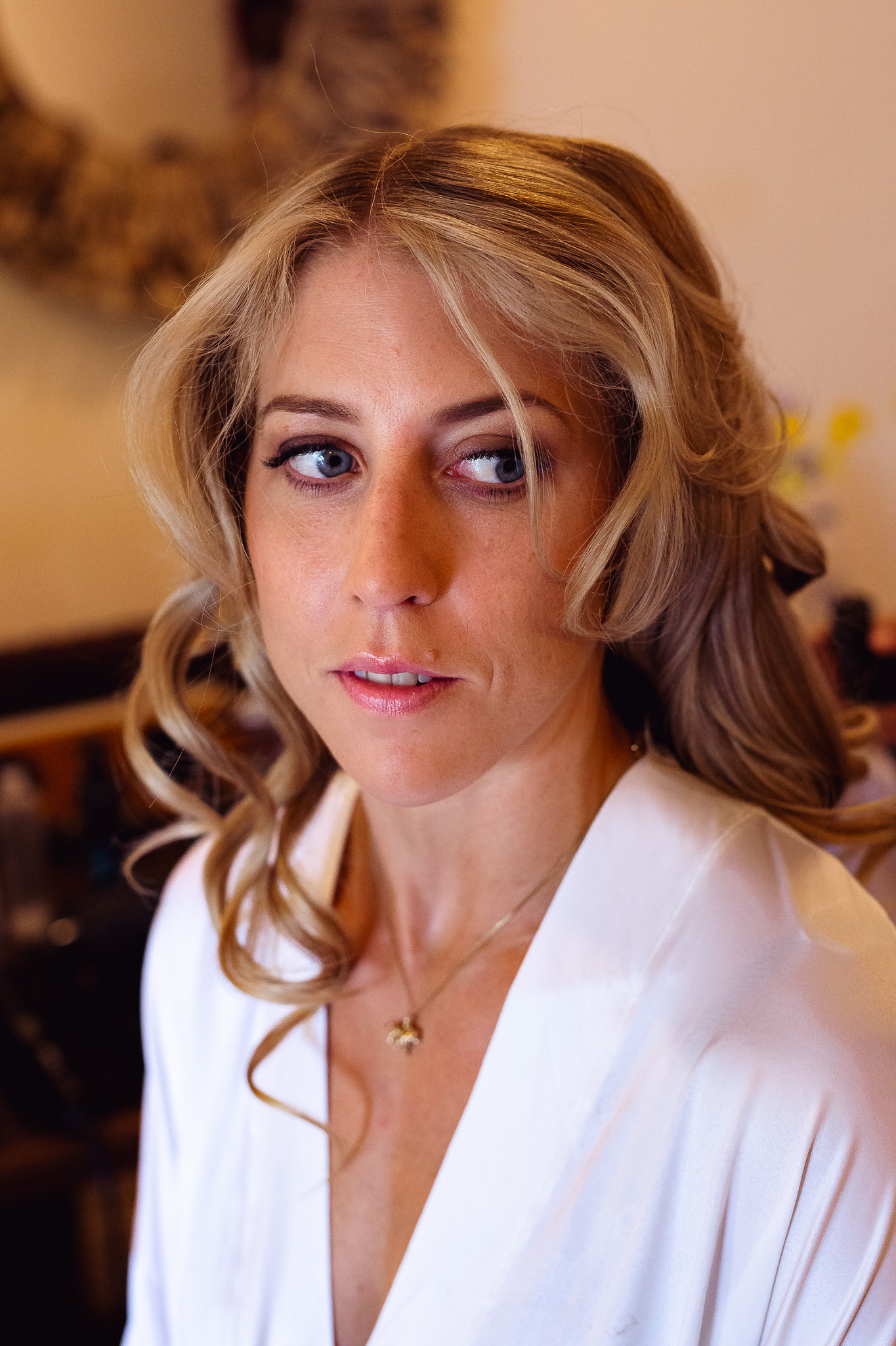 The bride with finished hair and make-up during her wedding preparation.