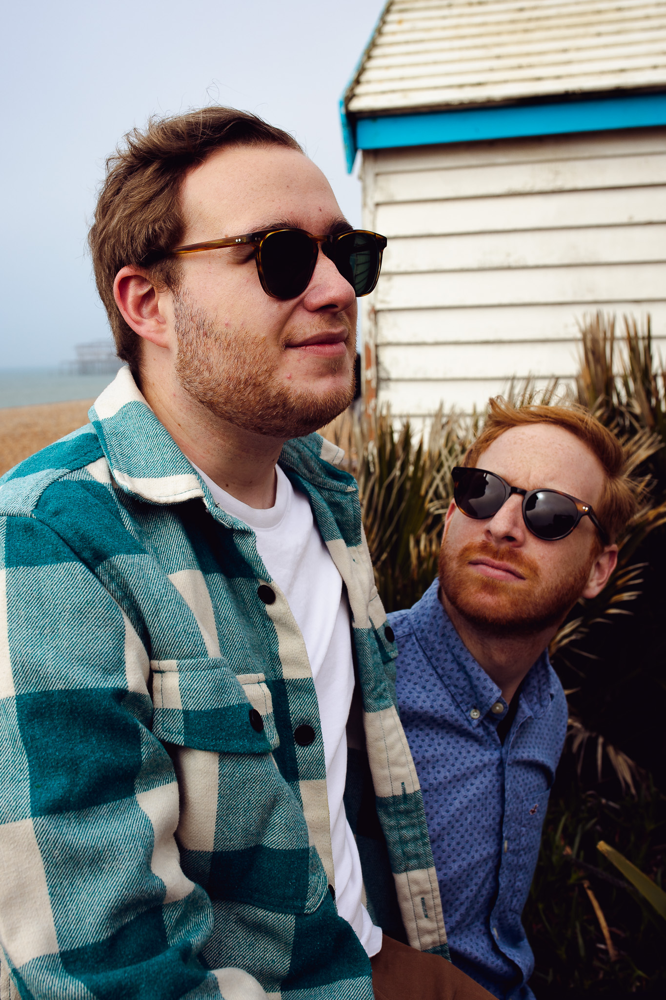 LGBTQ+ couple wearing sunglasses during their engagement session on Brighton Beach